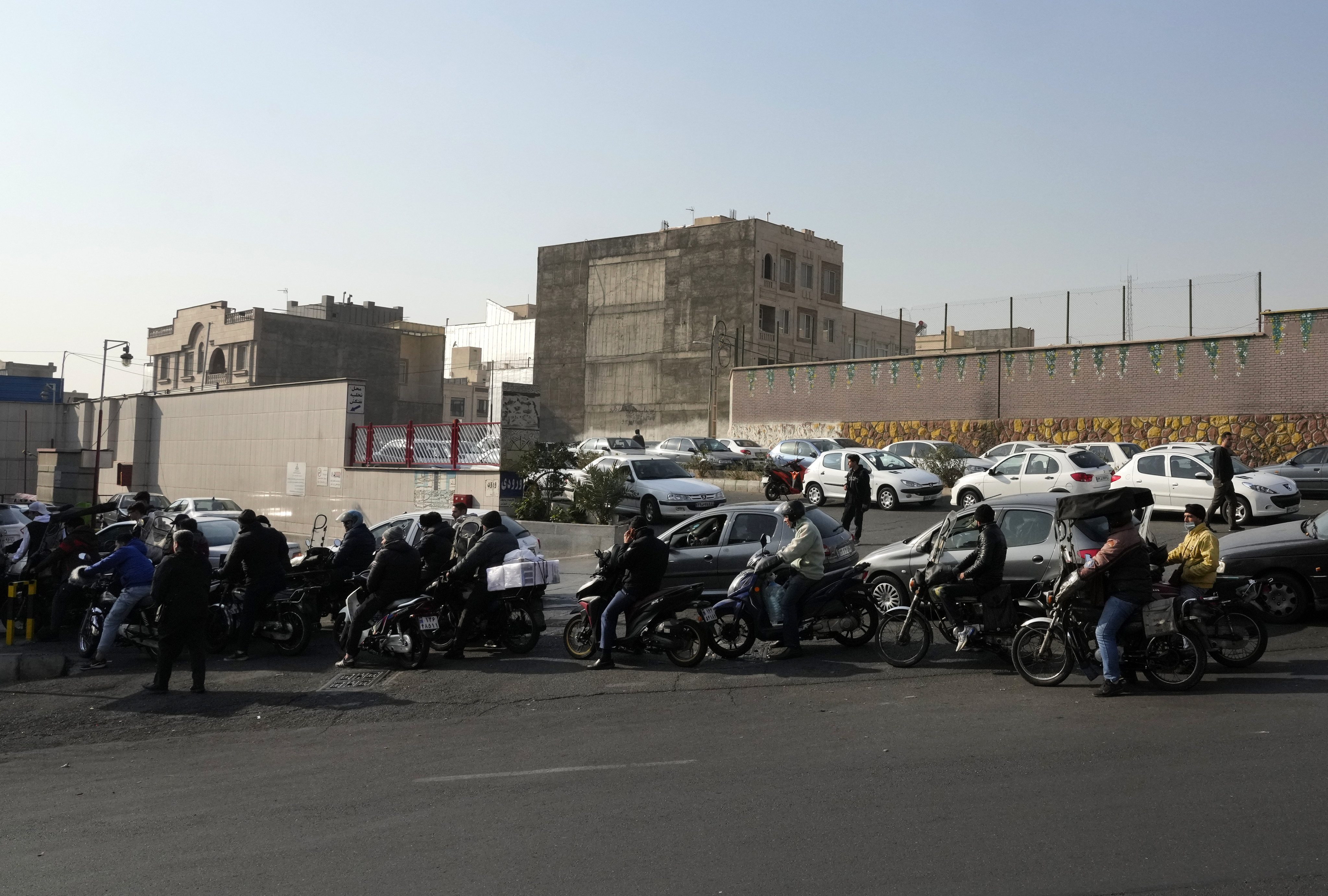 Motorcycles and cars queue up outside a petrol station in Tehran, Iran on Monday. Photo: AP