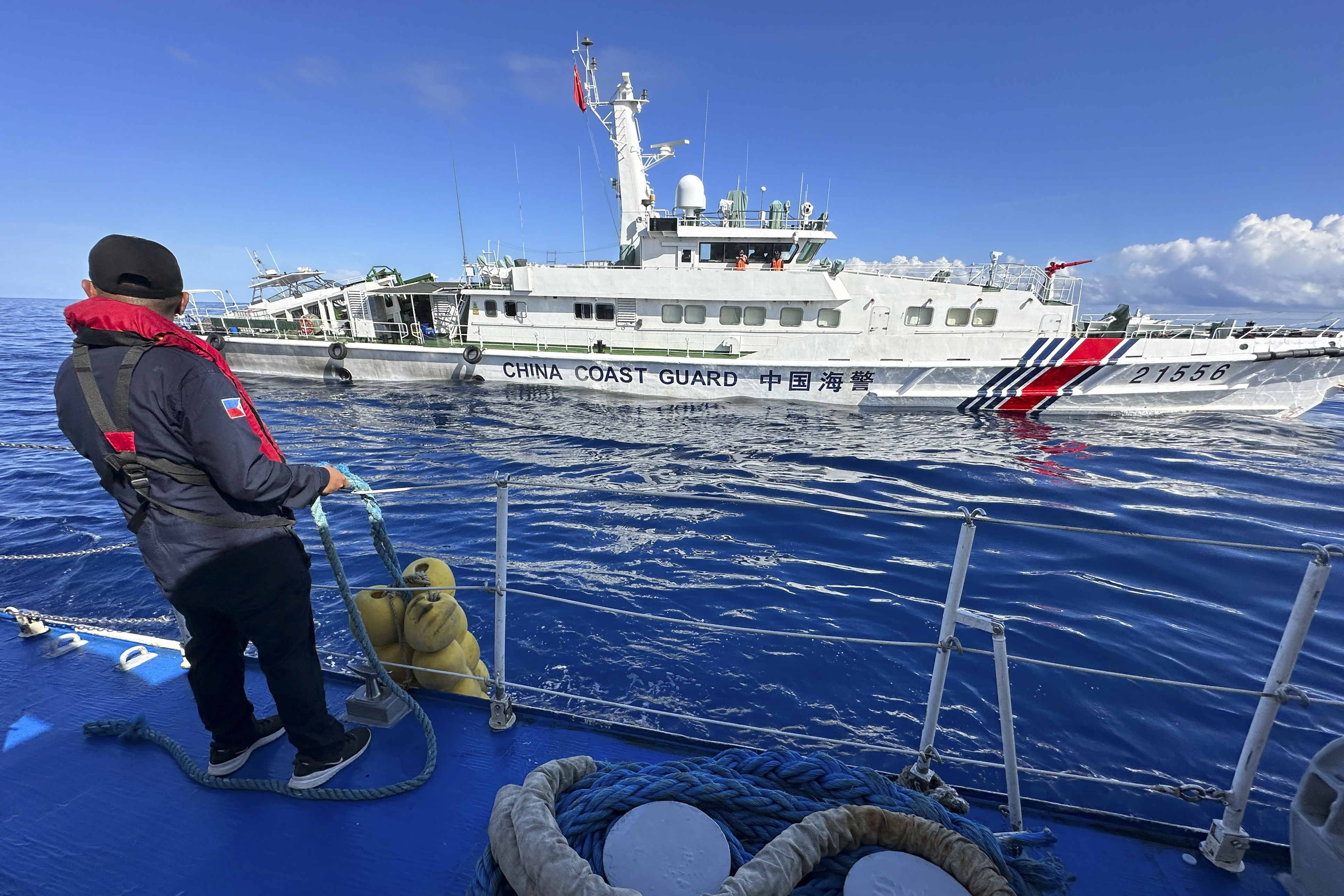 A Philippine coast guard member looks on as a Chinese coast guard vessel chases the Philippine coast guard vessel BRP Cabra while approaching Second Thomas Shoal during a resupply mission in the disputed South China Sea in November. Photo: AP