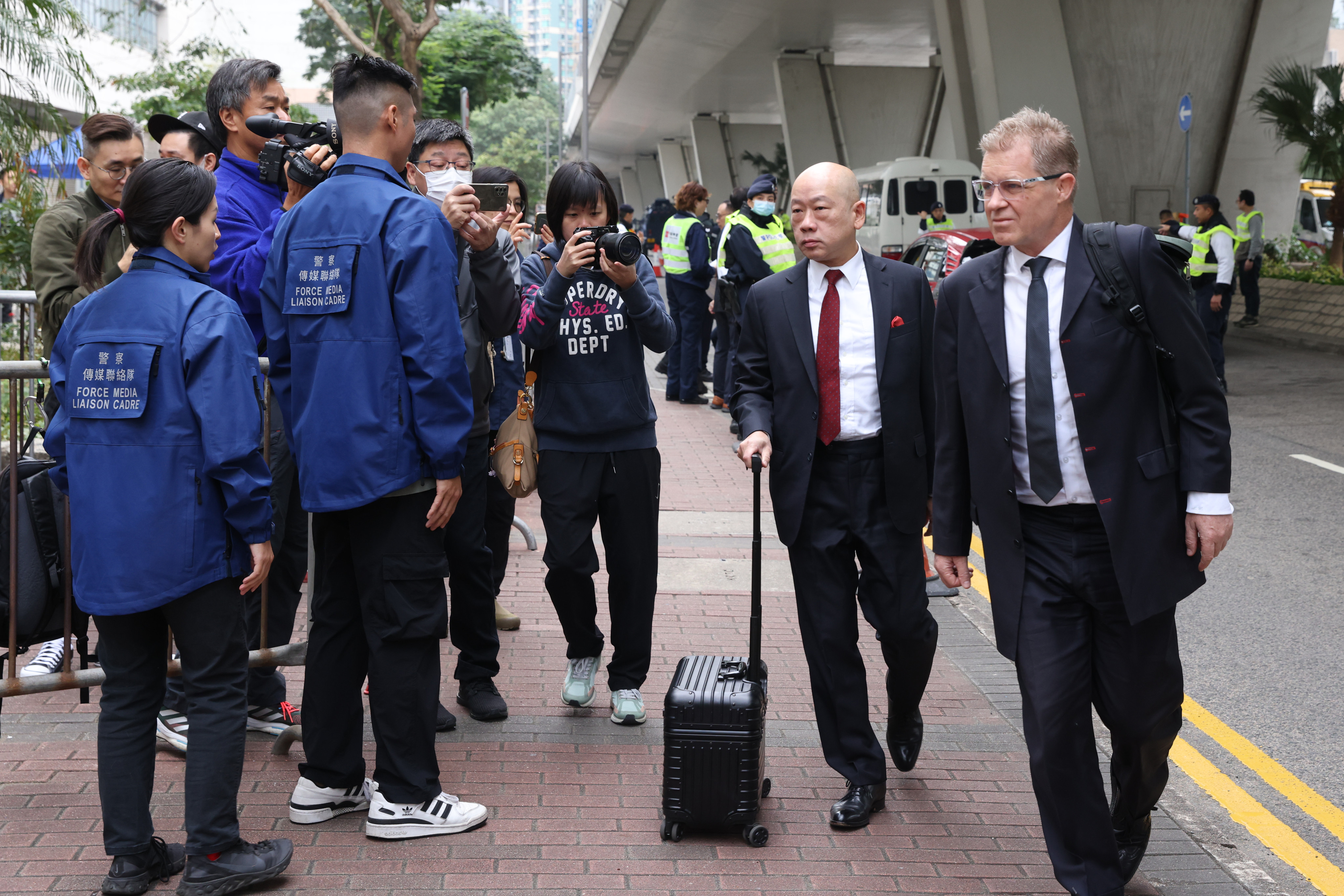 Jimmy Lai’s lawyers, Robert Pang (second right) and Marc Corlett, arrive at West Kowloon Court on Tuesday. Photo: Yik Yeung-man