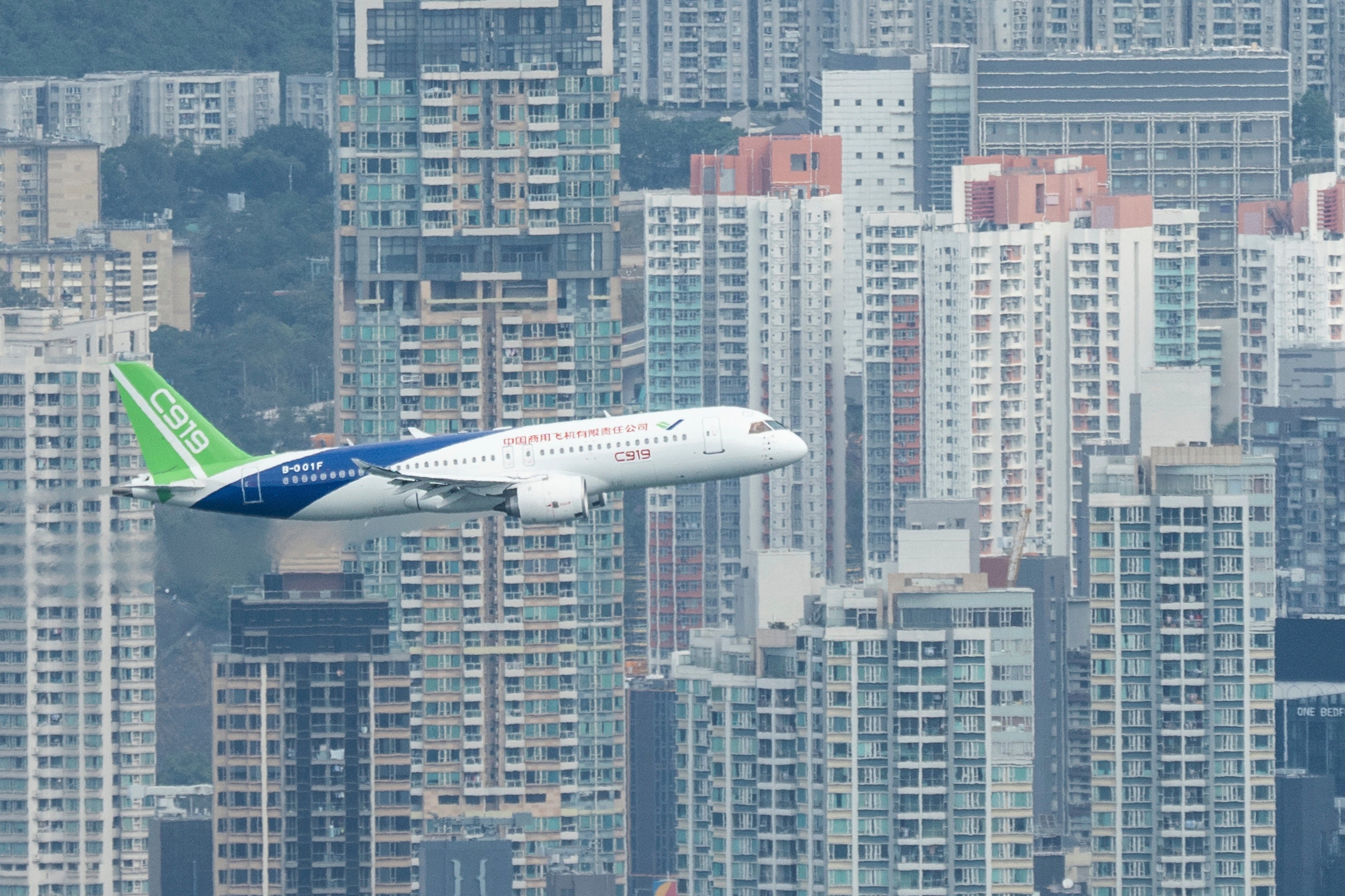 A Chinese-made C919 flies over Victoria Harbour on Saturday. Photo: AP