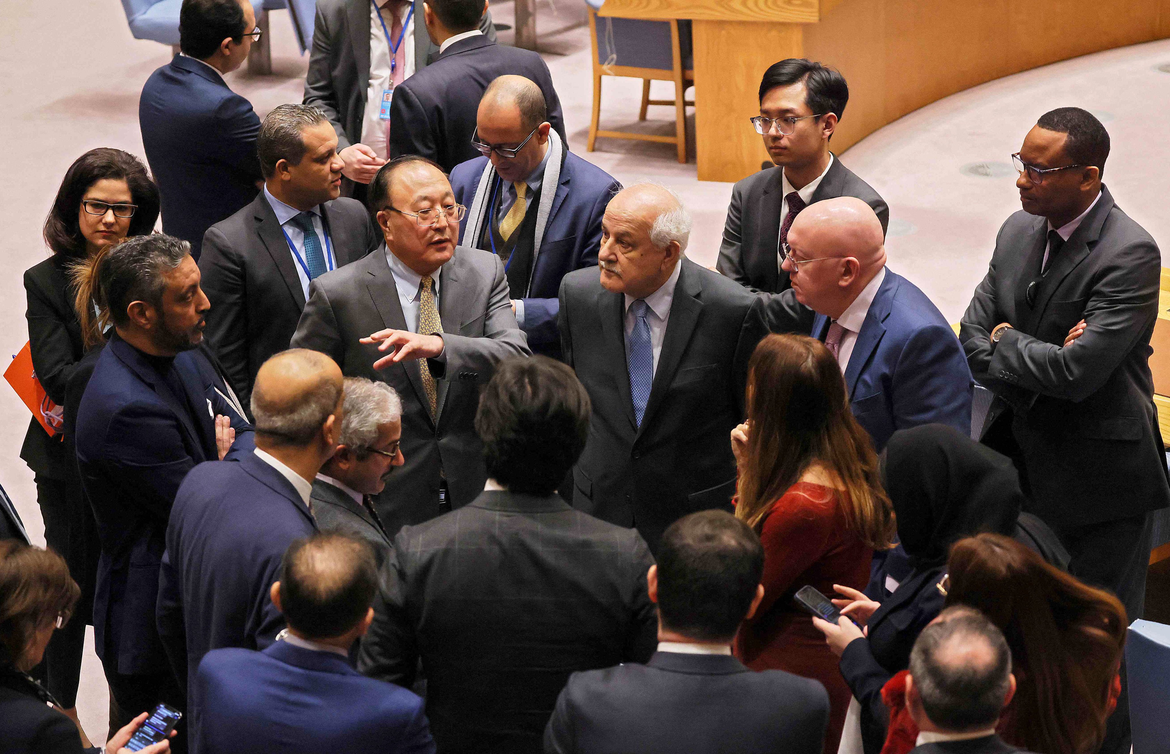 China’s permanent representative to the UN Zhang Jun (centre left) and the Palestinian ambassador to the United Nations Riyad Mansour (centre right)) during a break in the Security Council meeting on Tuesday. Photo: AFP
