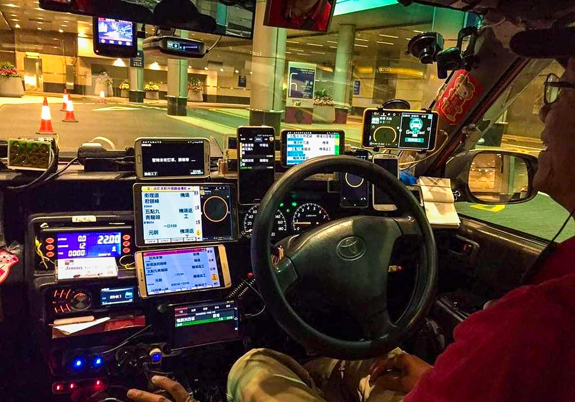 A taxi driver operating multiple devices on his dashboard. Cabbies have come under fire for poor service and overcharging passengers. Photo: Facebook/Man Kwong Battery