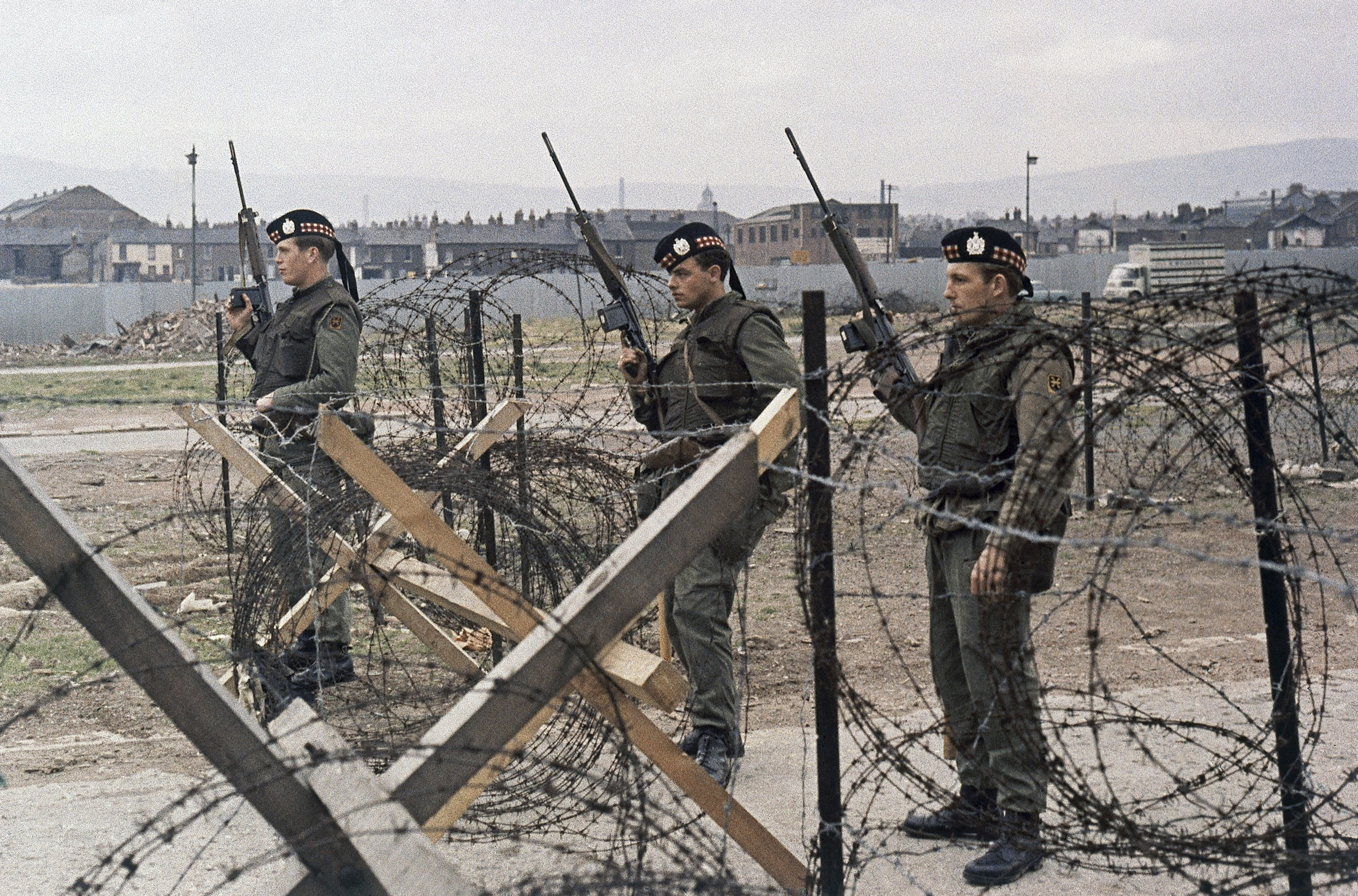 Troops from the King’s Own Scottish Regiment stand behind barbed wire in Belfast, Northern Ireland in 1970. The UK legislation proposes immunity from prosecution for British soldiers and security personnel from the time of “The Troubles” in Northern Ireland. Photo: AP