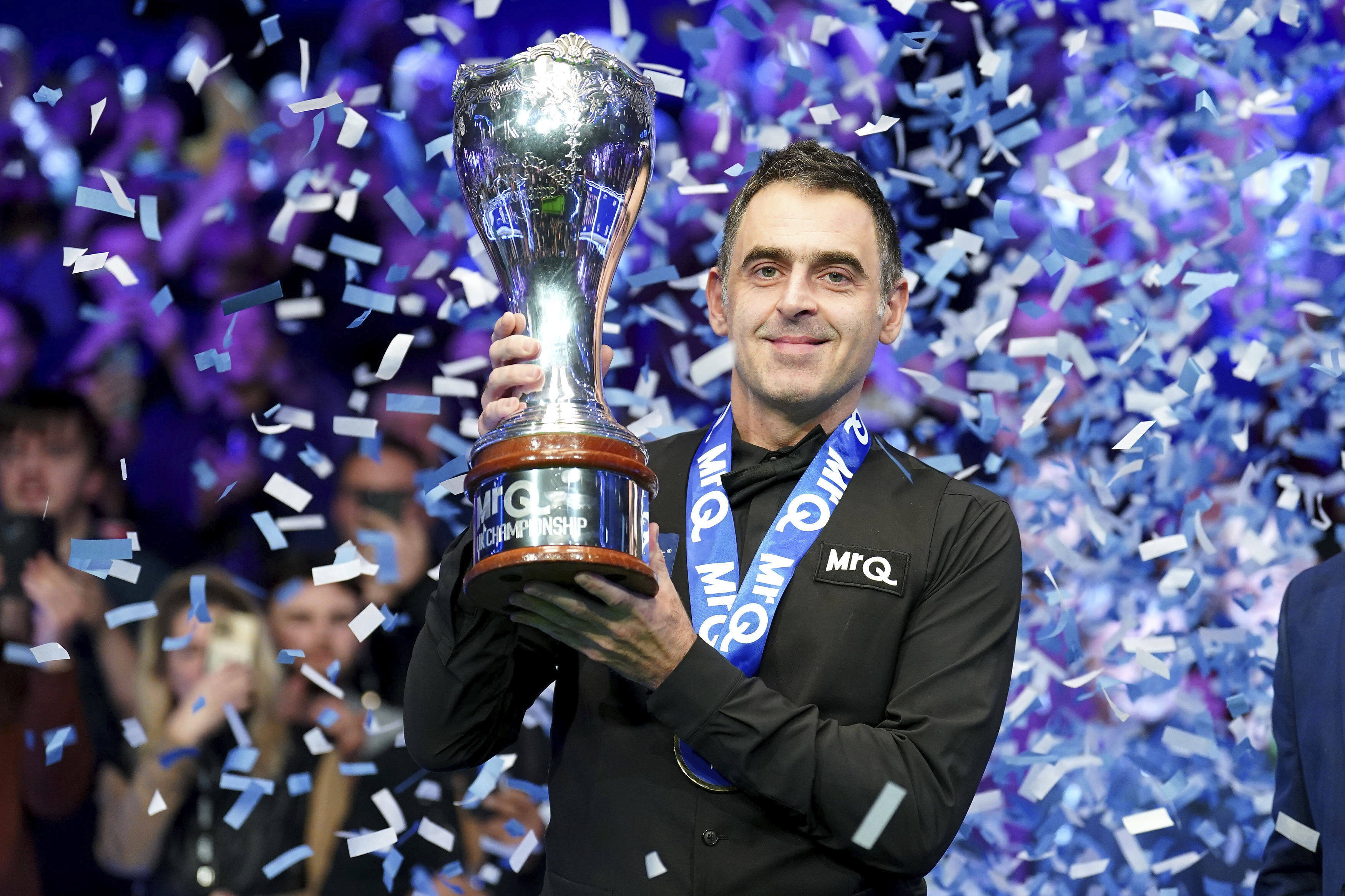 Ronnie O’Sullivan celebrates with the trophy after winning the UK Championship for a record eighth time. Photo: AP