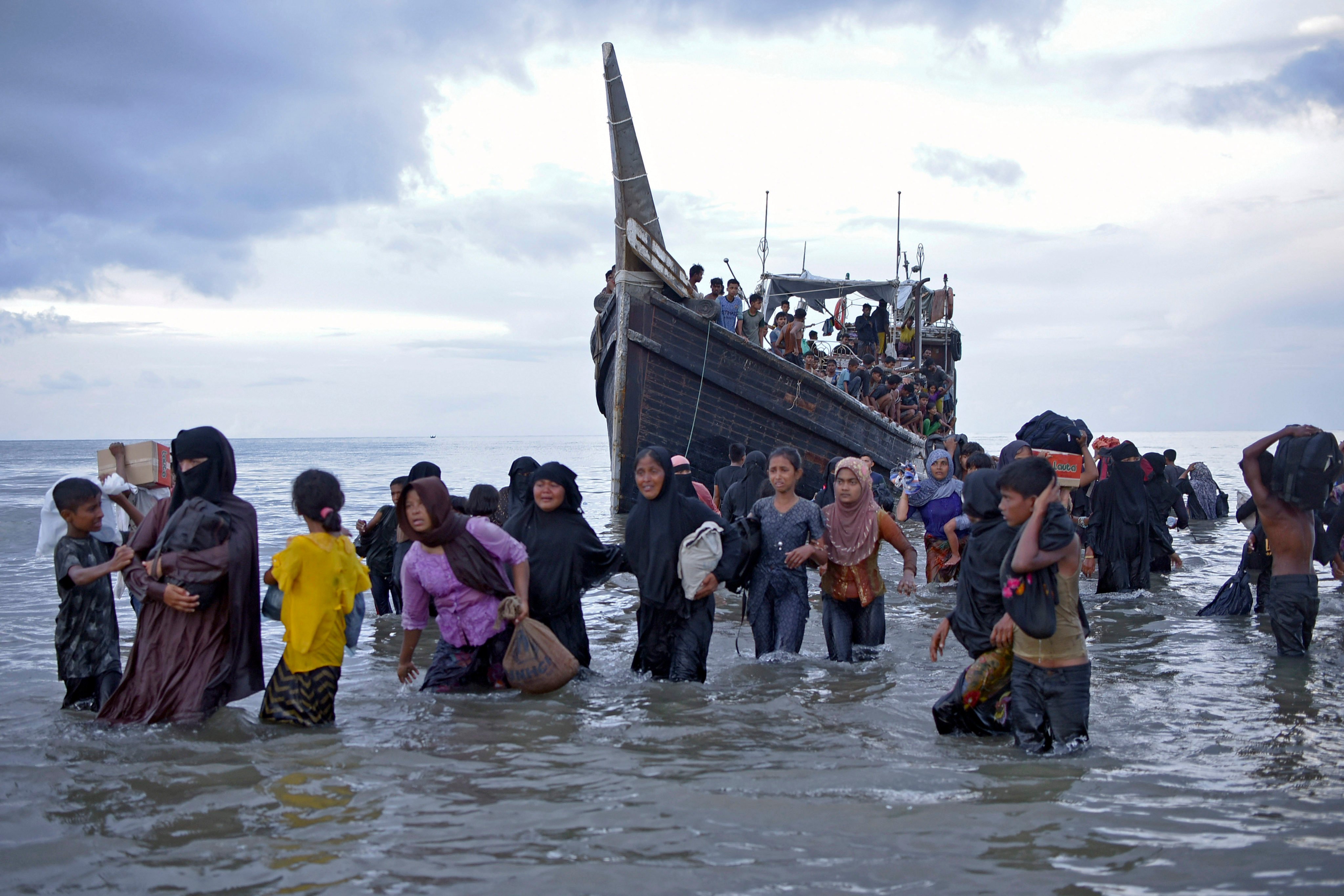 Rohingya refugees disembark from a boat upon landing in Indonesia’s Aceh province in November. More than 1,500 Rohingya Muslims have arrived in the province in recent weeks. Photo: AP