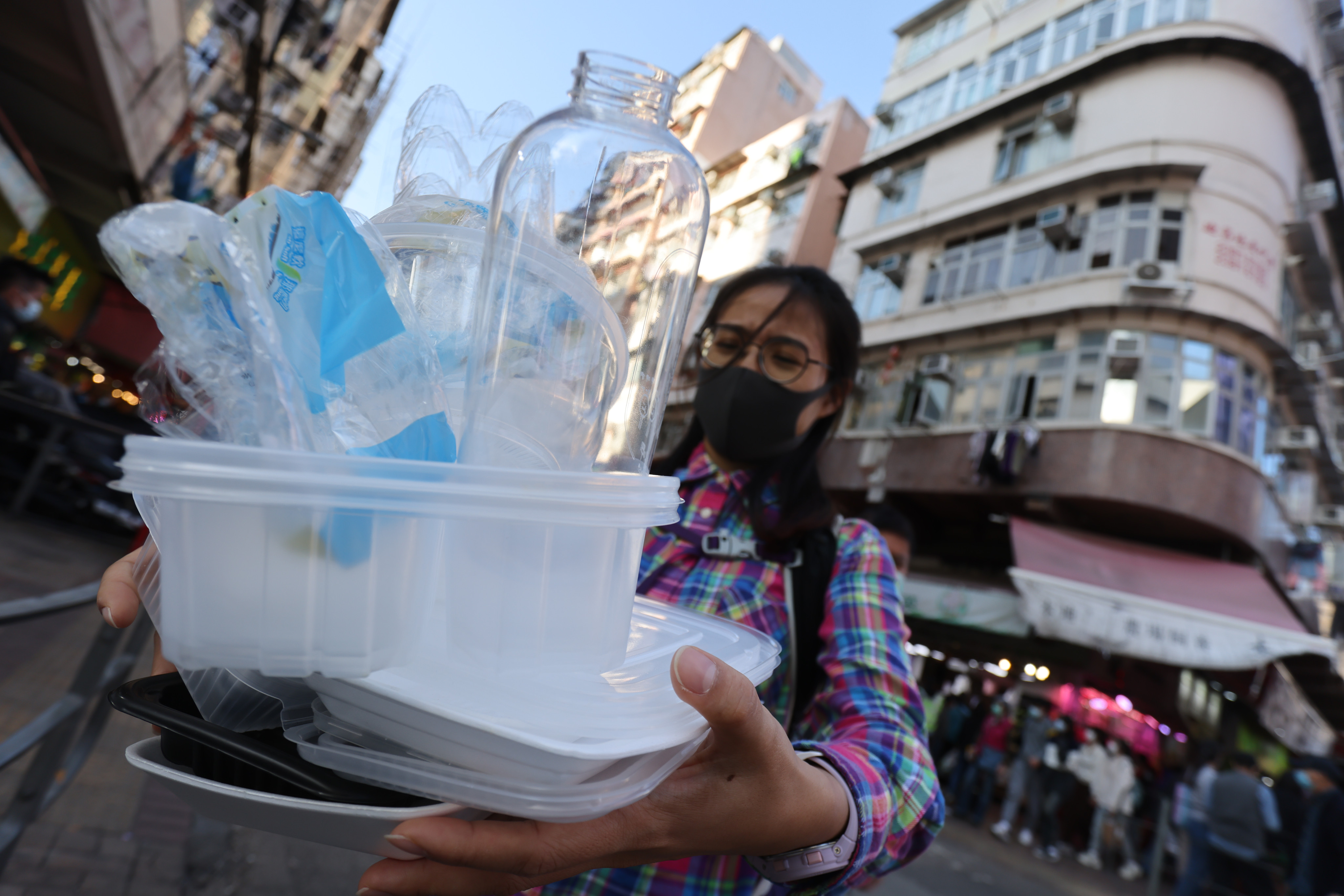 A resident at Sham Shui Po brings recyclables to a nearby community recycling station on December 22. The drive to get Hongkongers to recycle won’t take off without dedicated efforts to educate people. Photo: May Tse 