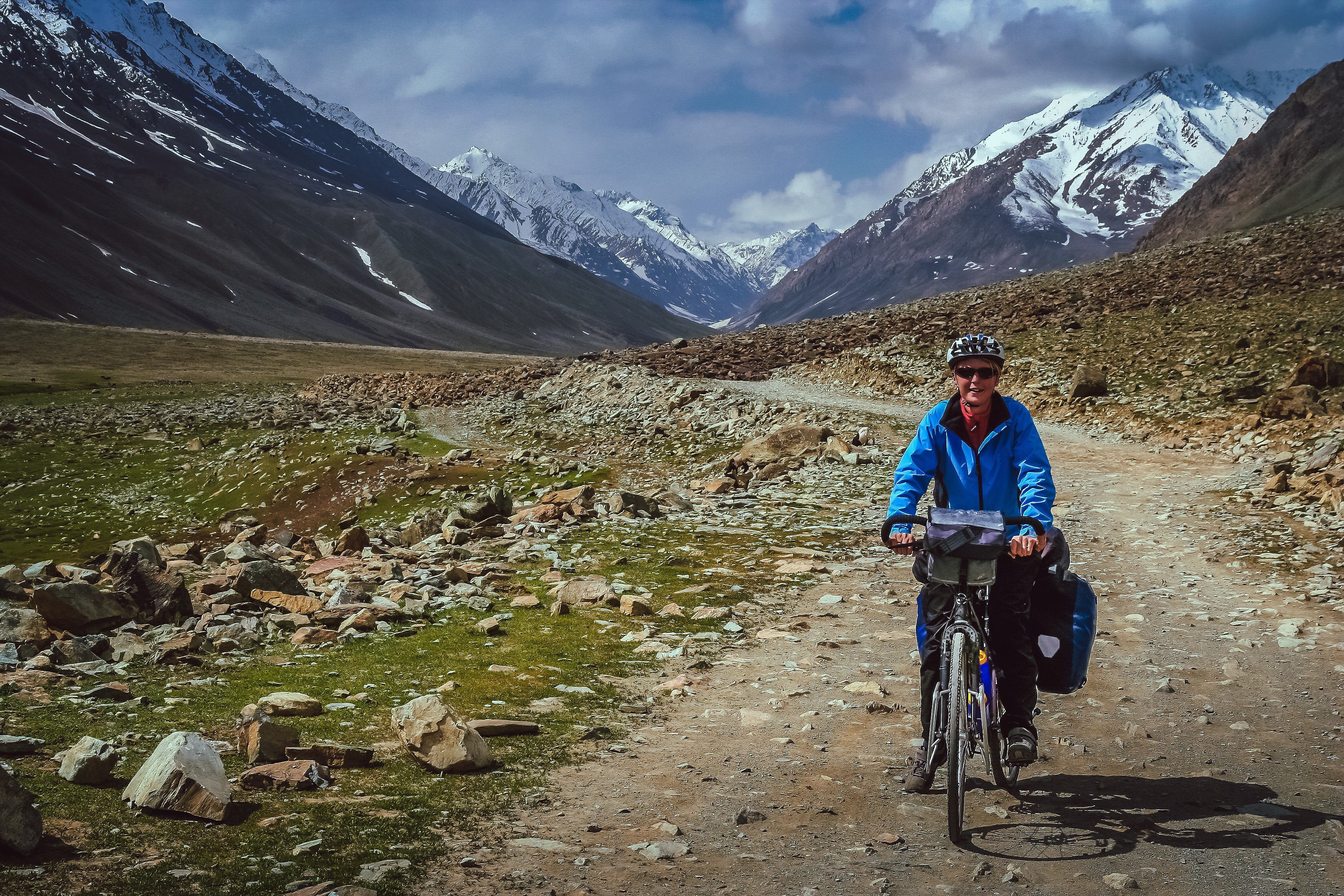 A cyclist makes their way along on a difficult mountain road towards Shandur Pass in northern Pakistan. Photo: Shutterstock Images