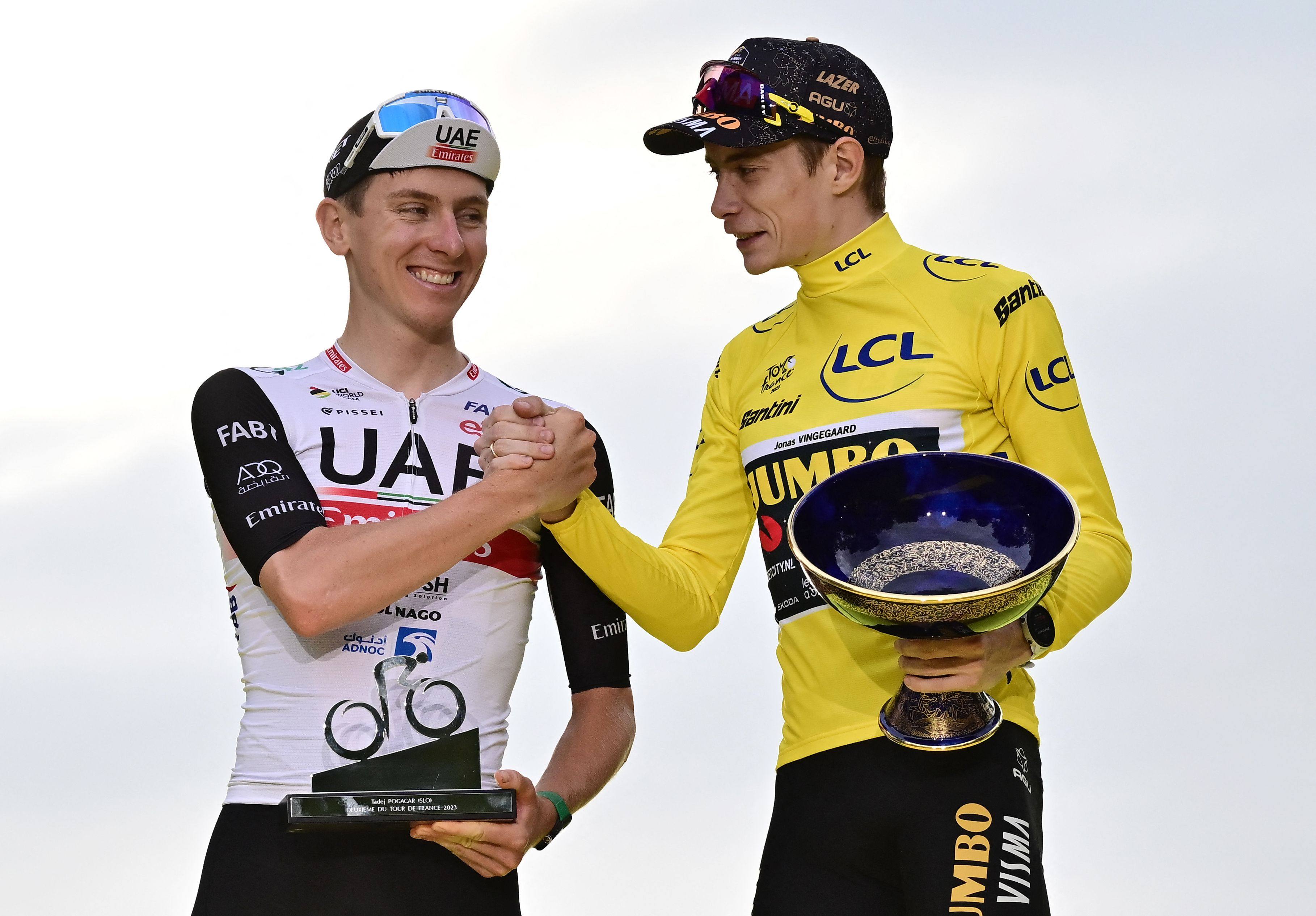 Jumbo-Visma’s Danish rider Jonas Vingegaard (right) with overall leader’s yellow jersey shakes hands with UAE Team Emirates’ Slovenian rider Tadej Pogacar after winning the 21st and final stage of the 110th edition of the Tour de France. Photo: AFP