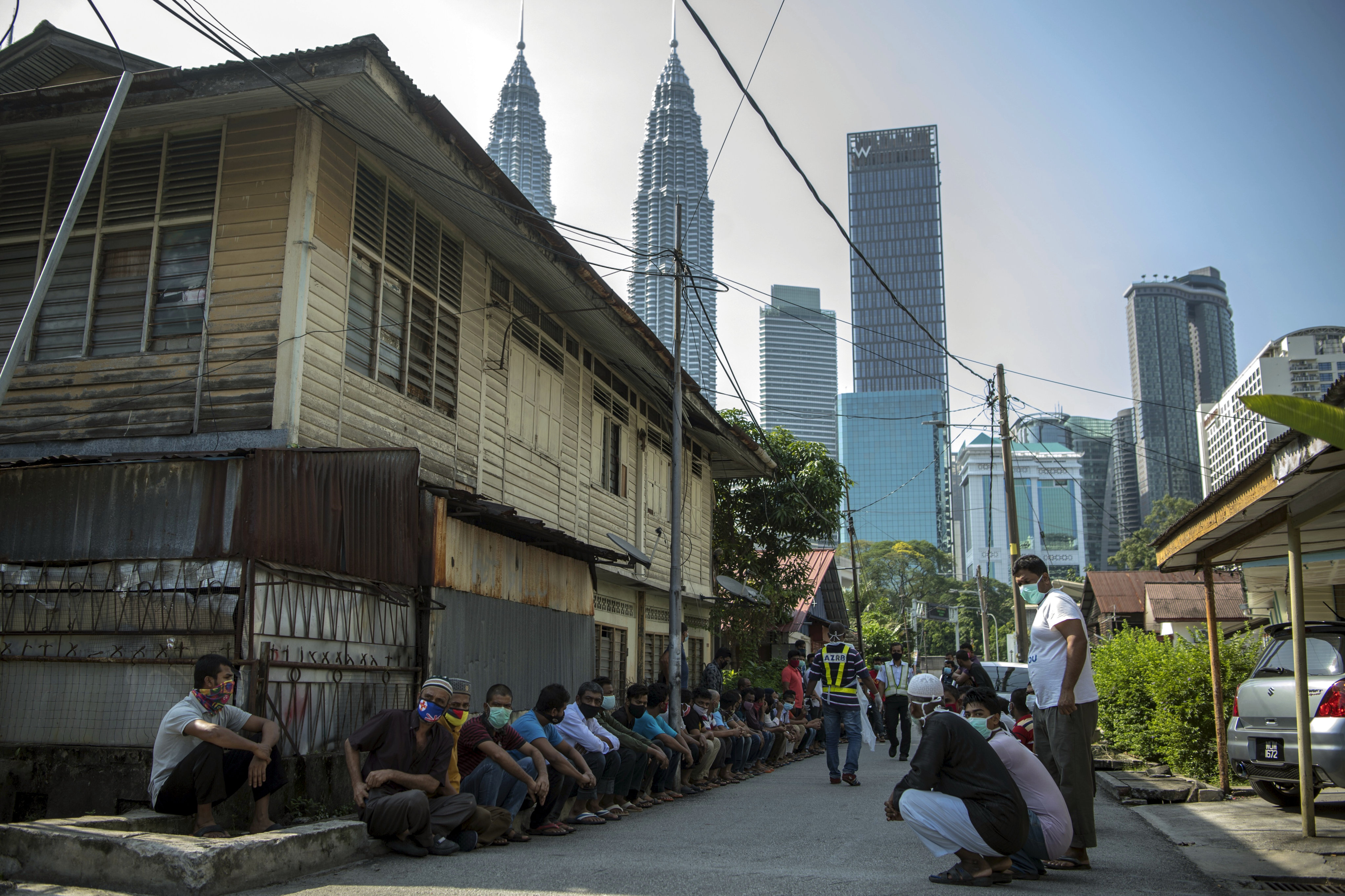 Foreign workers in Kuala Lumpur line up during a coronavirus screening process in 2020. Photo: Mustaqim Khairuddin/Bernama/dpa