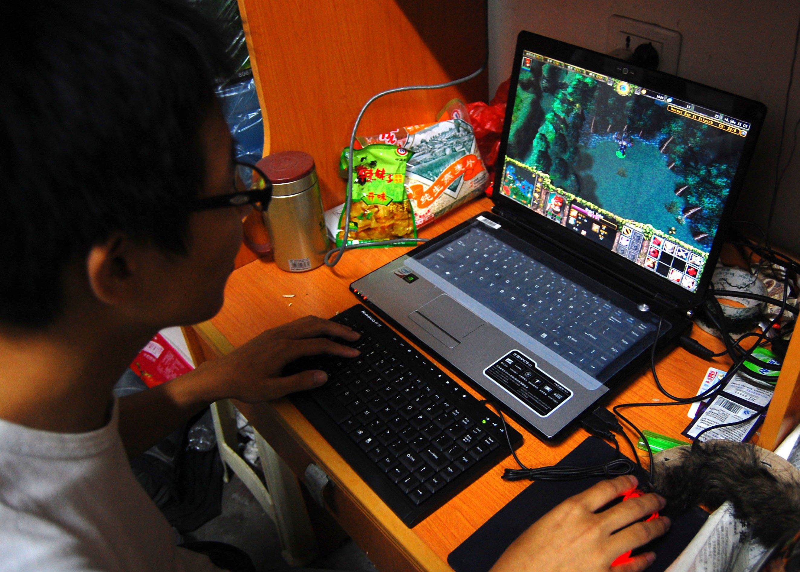 A college student plays the online game World of Warcraft in his dormitory room in southwest China’s Chongqing. Photo: AP