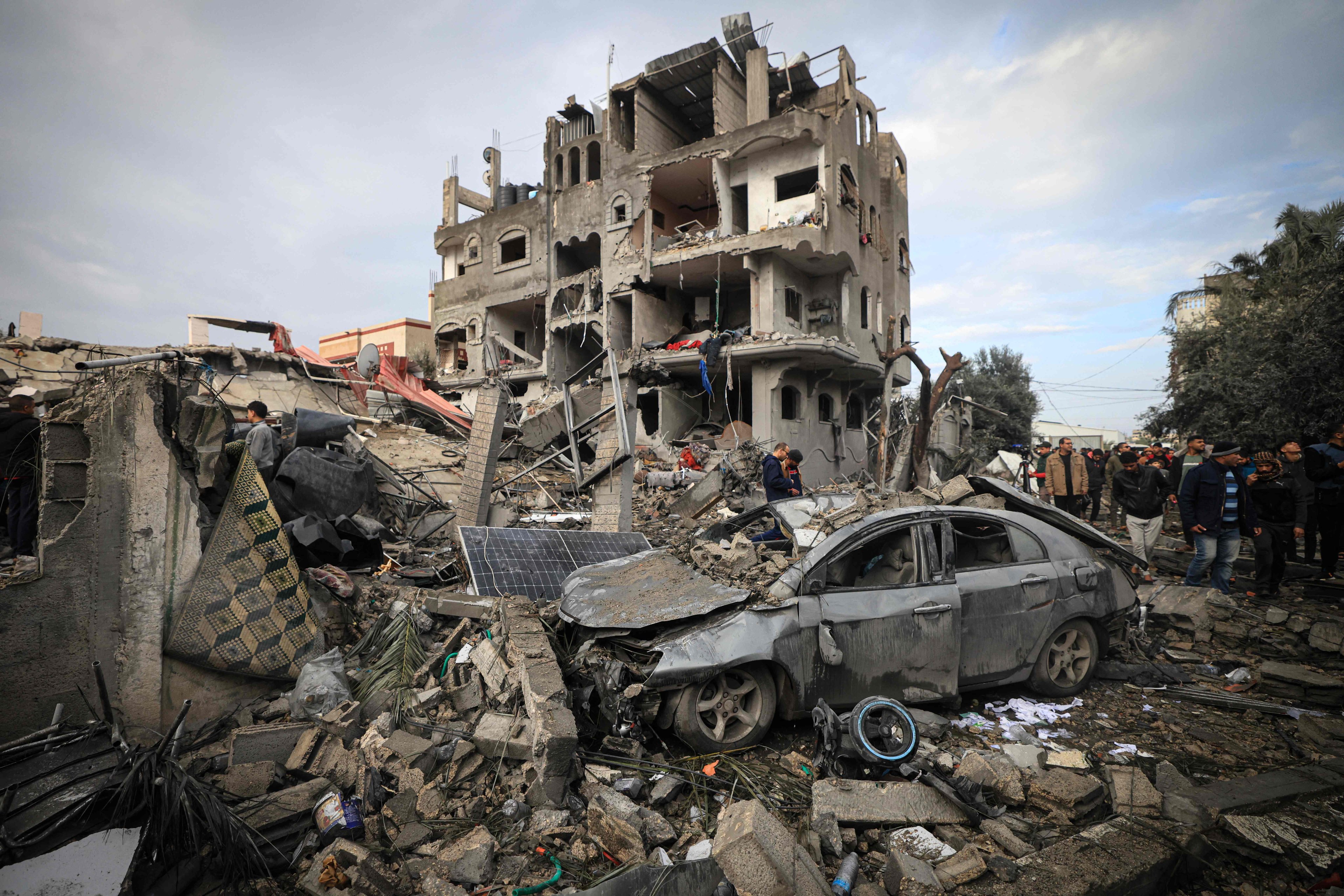 Palestinians inspect the damage at the Al-Maghazi refugee camp after an overnight Israeli strike on Monday. Photo: AFP