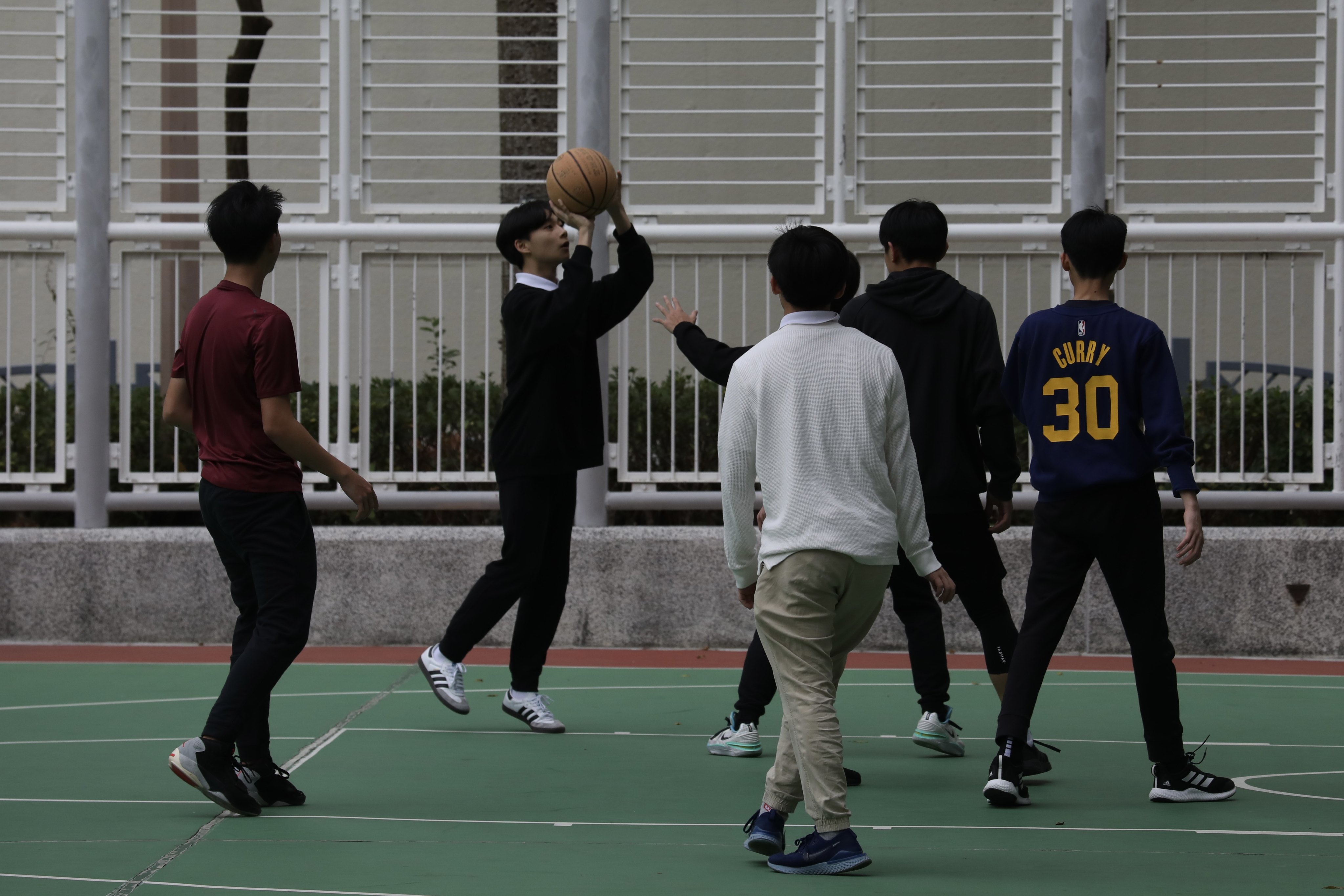 Young people play basketball in Tiu Keng Leng on December 20. The recent rise in teenage suicides and concerns about the poor state of Hong Kong young people’s mental health have spurred the government to action. Photo: Sun Yeung