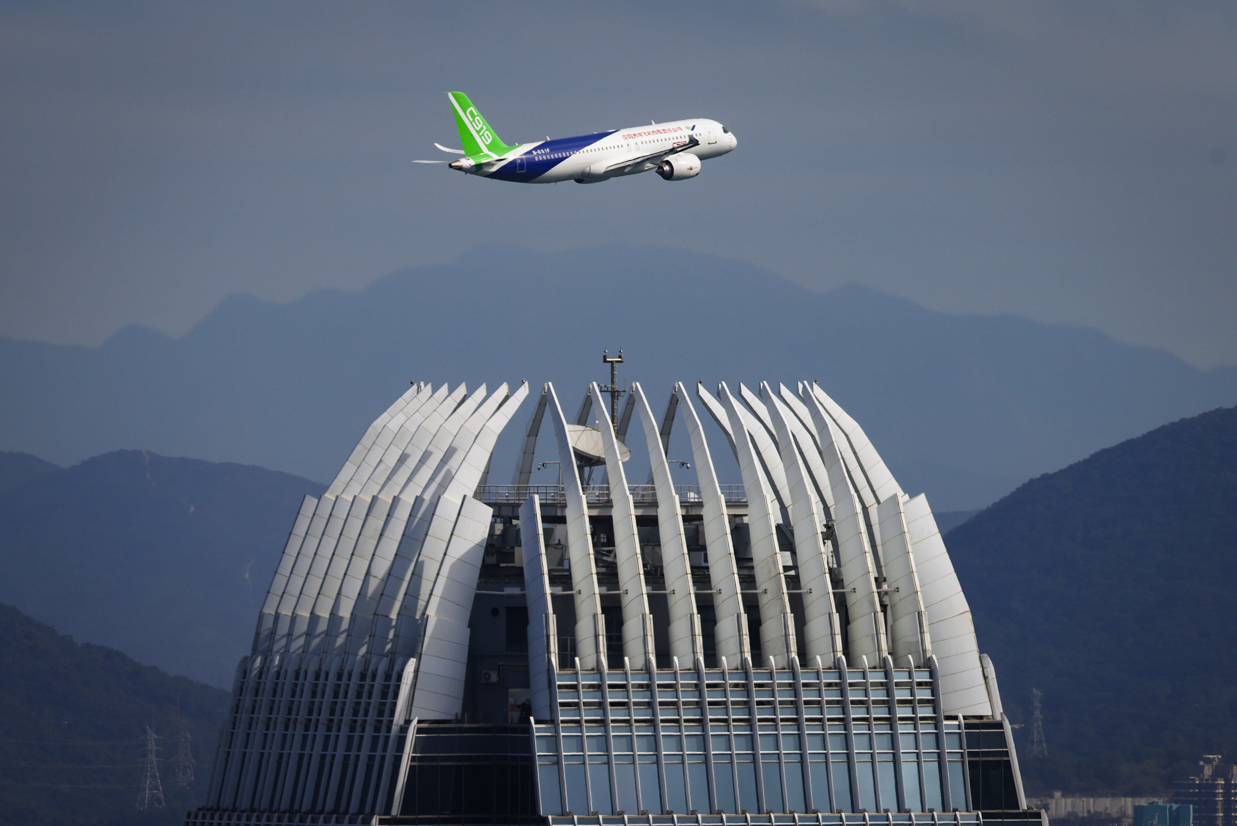 A C919 jet flies over Victoria Harbour in Hong Kong as part of a demonstration flight on December 16. Photo: Dickson Lee