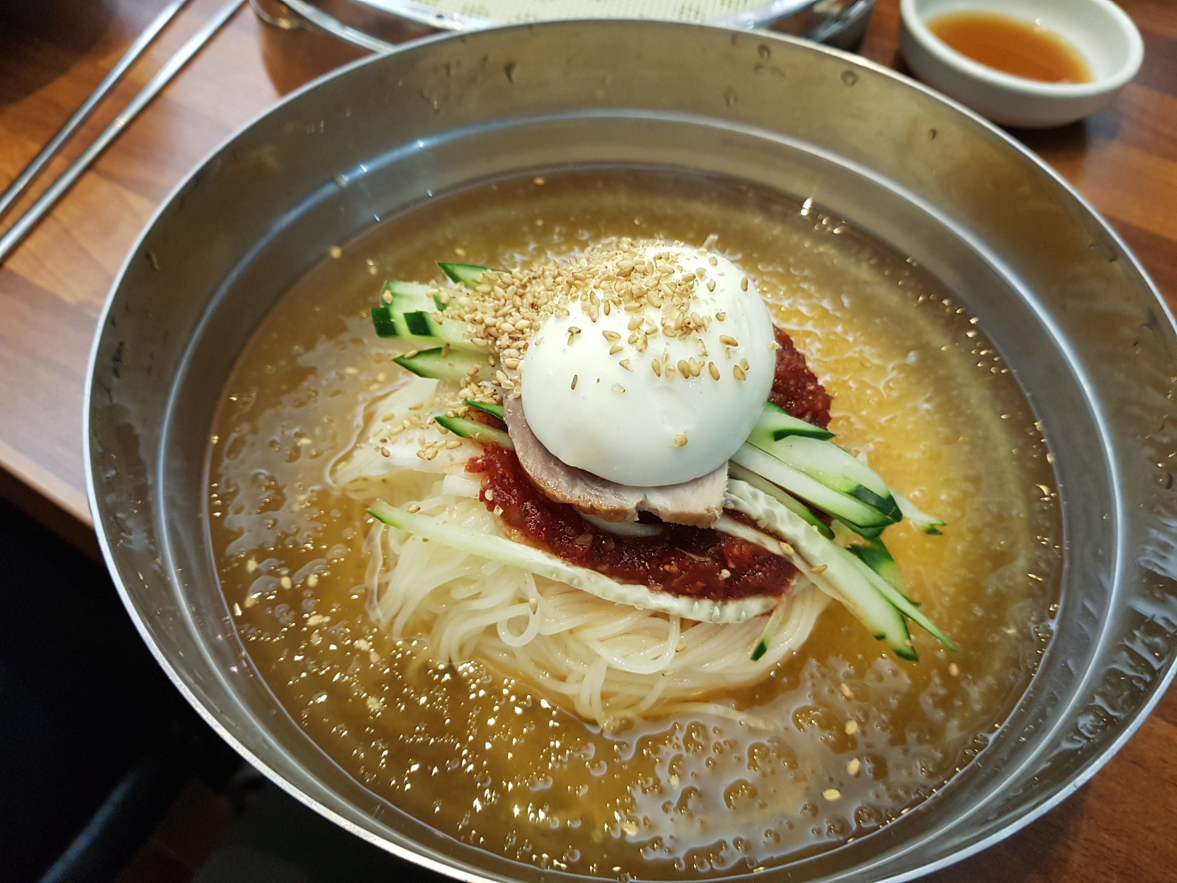 Busan’s signature cold wheat noodle dish was invented by refugees who fled North Korea during the Korean war. Decades later, the dish represents the homeland that many with North Korean heritage long to return to but cannot visit. Photo: Shutterstock