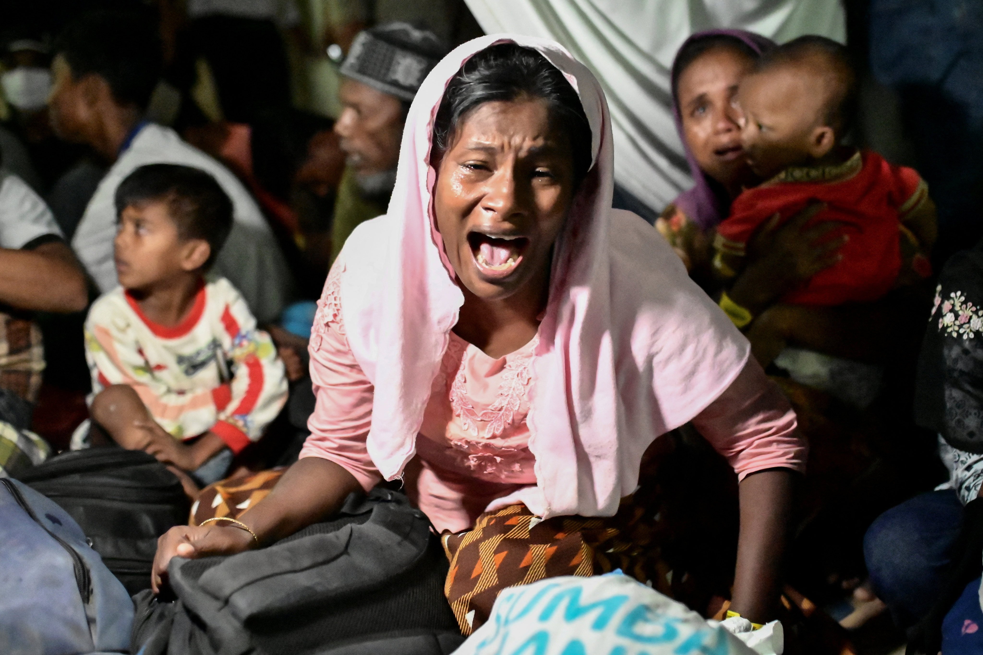 A Rohingya Muslim woman reacts as she is relocated from her temporary shelter following a protest for the deportation of the Rohingya refugees in Banda Aceh, Indonesia on Thursday. Photo: Reuters