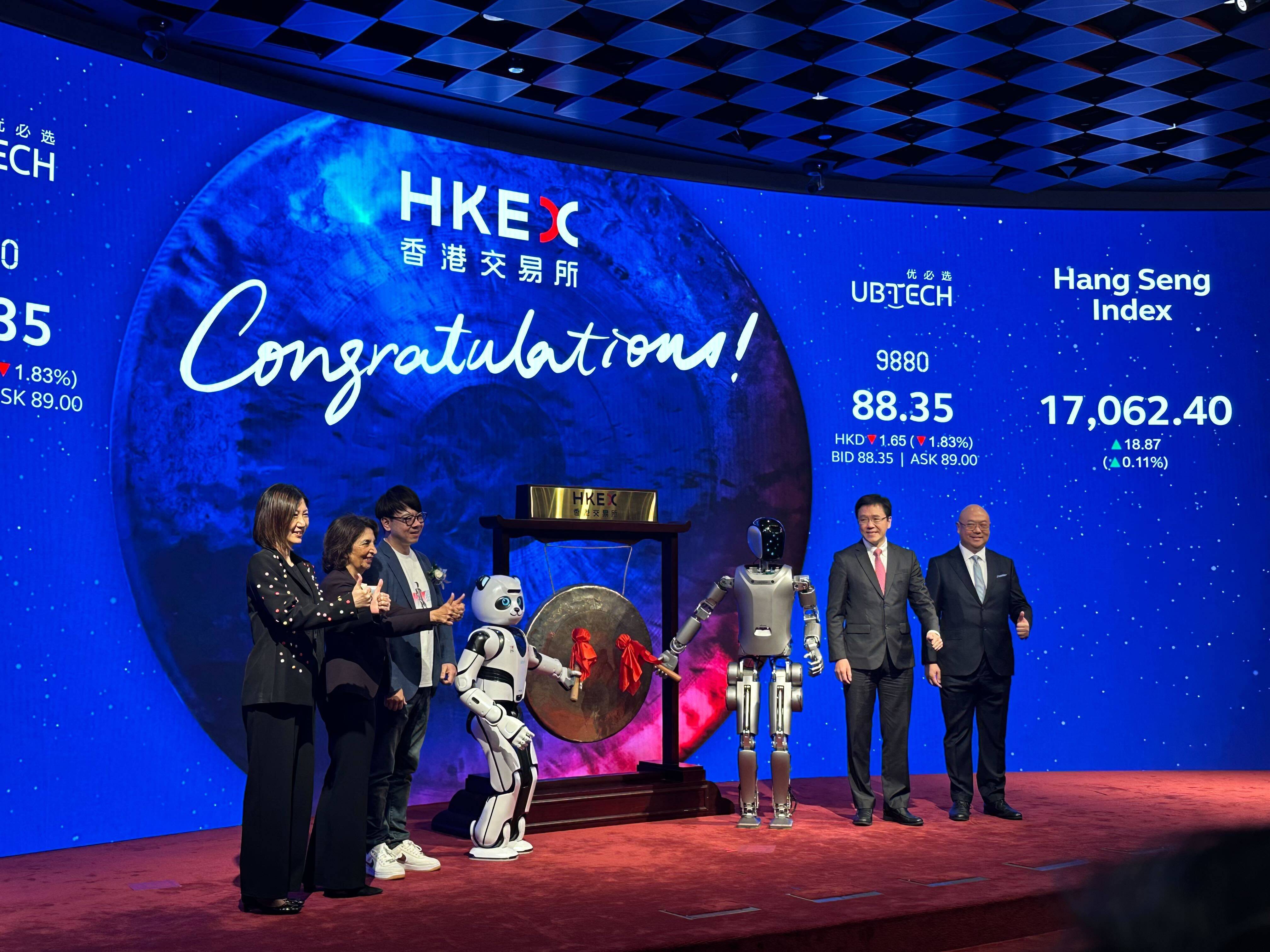 UBTech founder Zhou Jian and the firm’s Walker S humanoid robot strike the listing gong to mark the stock debut in Hong Kong on December 29, 2023. Photo: Yujie Xue 