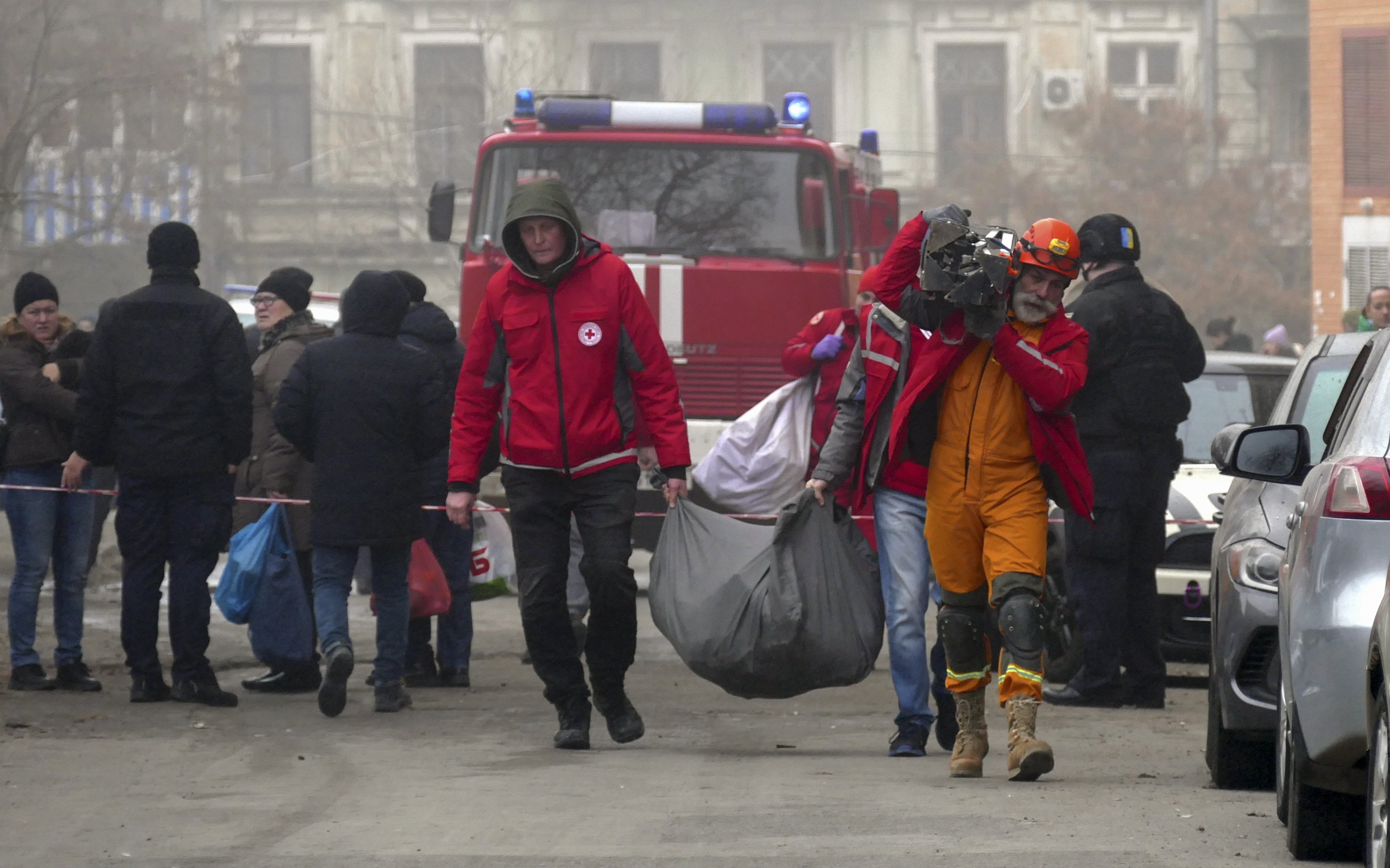 epa11048068 Ukrainian rescuers carry a bag from the site of a damaged building after shelling in Odesa, southwestern Ukraine, 29 December 2023, amid the Russian invasion. At least 18 people have died and over 130 were injured after Russia launched a wave of airstrikes across Ukraine, Ukraine’s Ministry of Internal Affairs said on 29 December. Strikes were reported in Kyiv, Lviv, Odesa, Dnipro, Kharkiv, Zaporizhzhia, and other Ukrainian cities. Russia launched ‘more than 150 missiles and combat drones’ at Ukrainian cities, Ukraine’s Prosecutor General Andriy Kostin said in a statement, adding that extensive damage included residential buildings, educational institutions and hospitals. Russian troops entered Ukraine on 24 February 2022 starting a conflict that has provoked destruction and a humanitarian crisis.  EPA-EFE/IGOR TKACHENKO