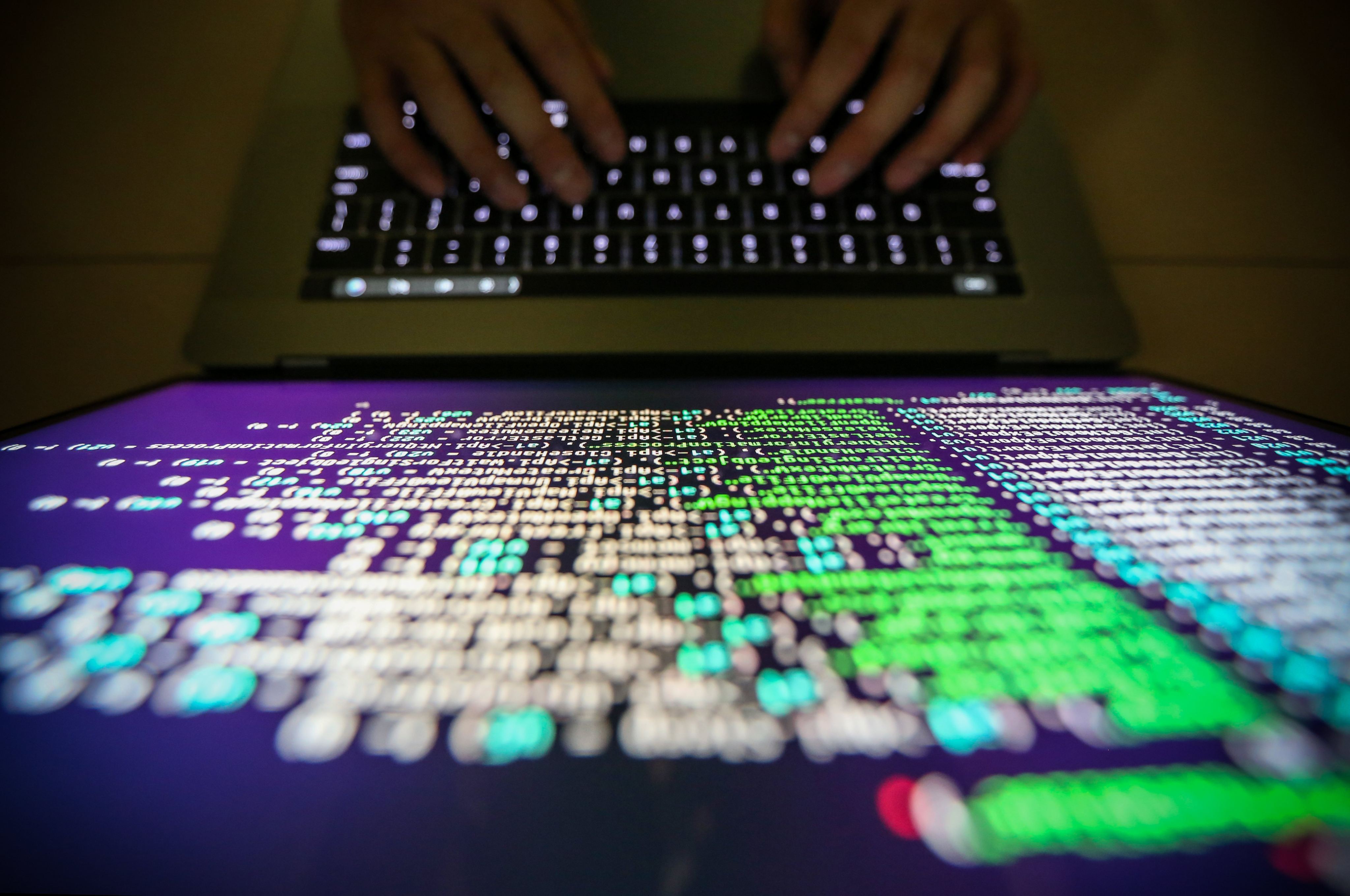 A programmer shows an example of decrypting source code in Taipei on May 13, 2017. Photo: EPA