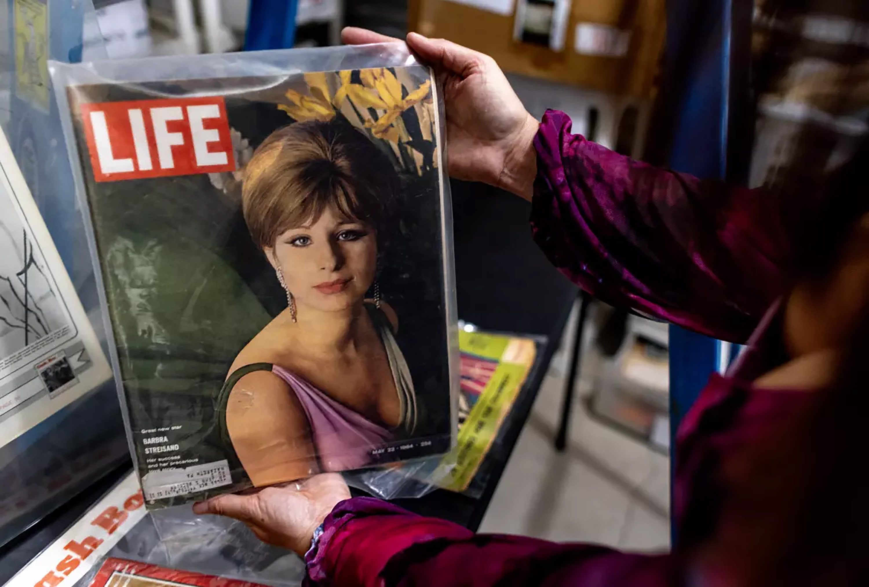 Mara Papalas holds a Life magazine cover featuring Barbra Streisand from May 22, 1964. Photo: Los Angeles Times/TNS