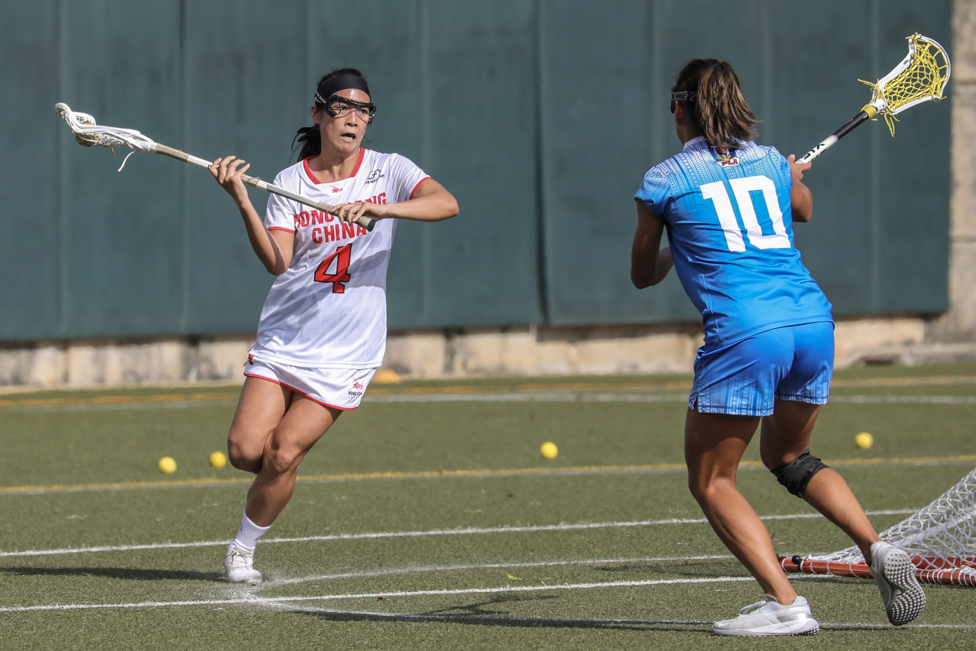 Hong Kong’s Leona Chak (left) drives forward during her side’s game against the  Philippines at the World Lacrosse Super Sixes. Photo: Xiaomei Chen