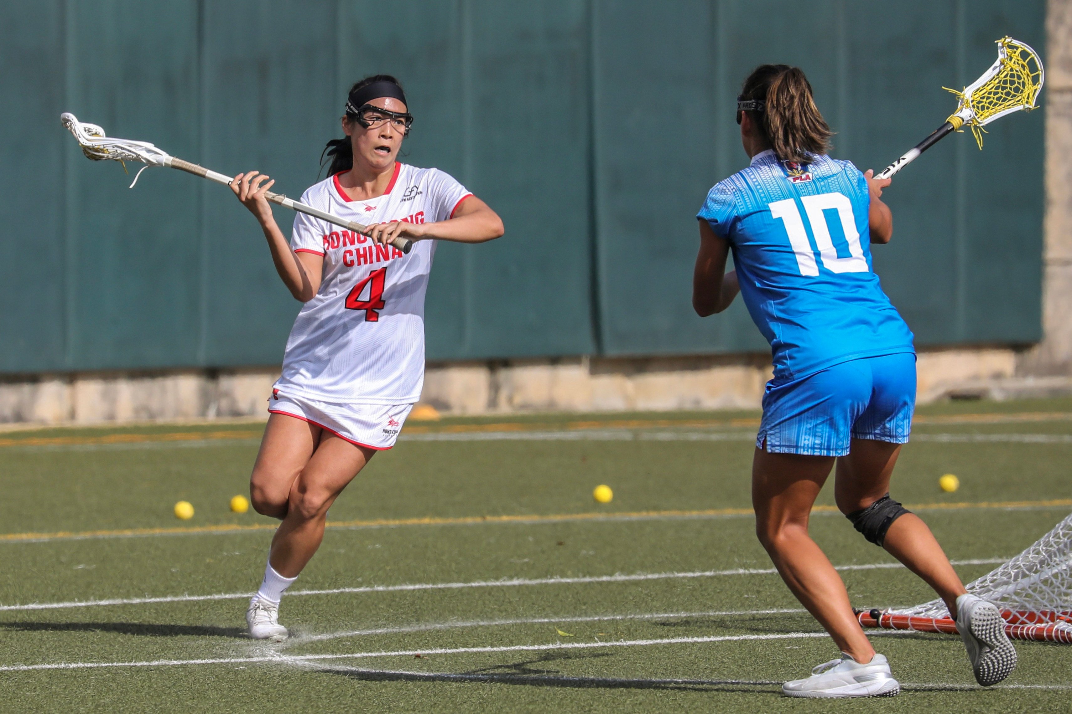 Hong Kong’s Leona Chak (left) drives forward during her side’s game against the  Philippines at the World Lacrosse Super Sixes. Photo: Xiaomei Chen