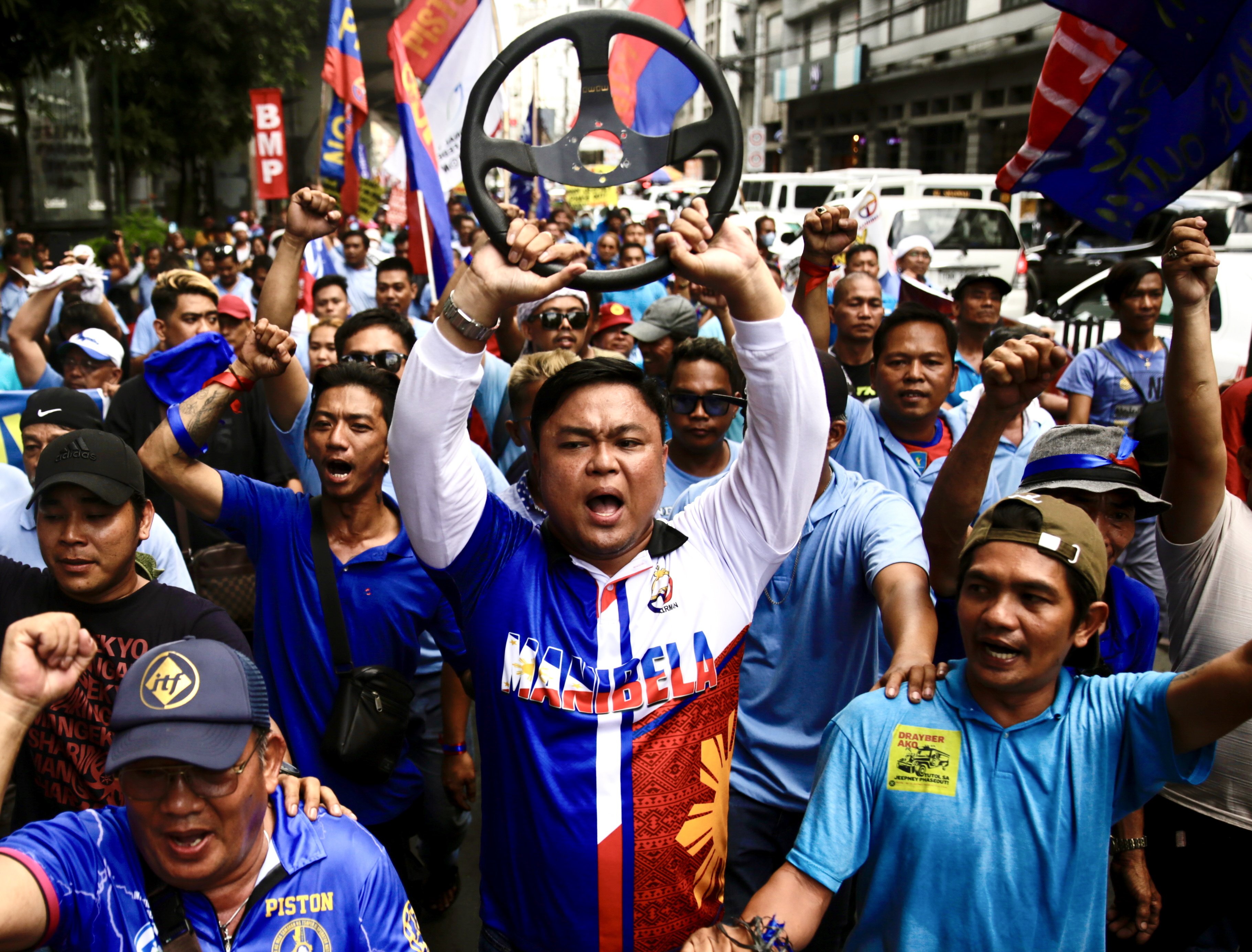 Jeepney drivers shout slogans as they stage a protest rally during a transport strike in Manila on December 29. Photo: EPA-EFE