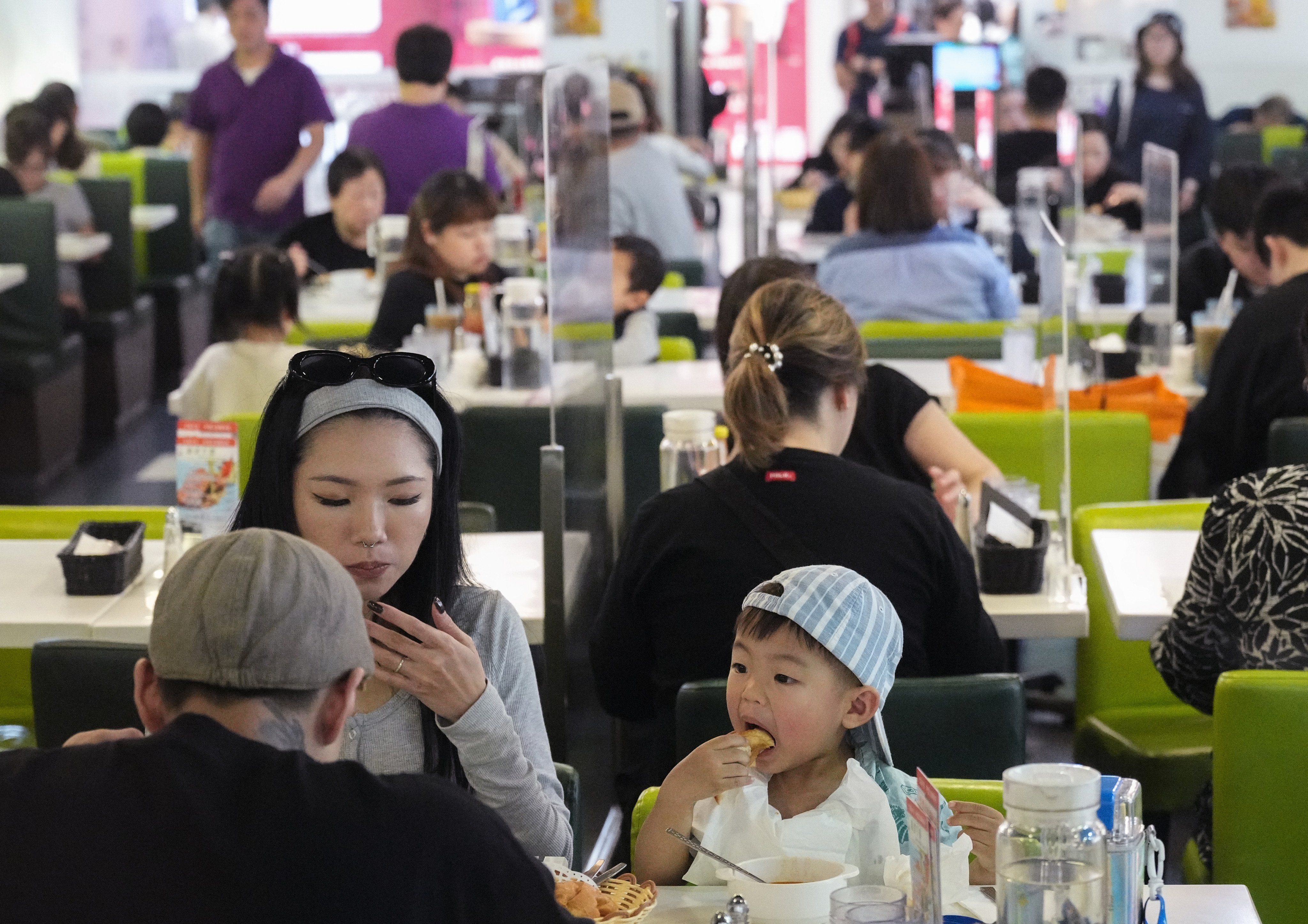 A youngster enjoys some food on the last day of the year but Hong Kong restaurants are not happy about business. Photo: Eugene Lee