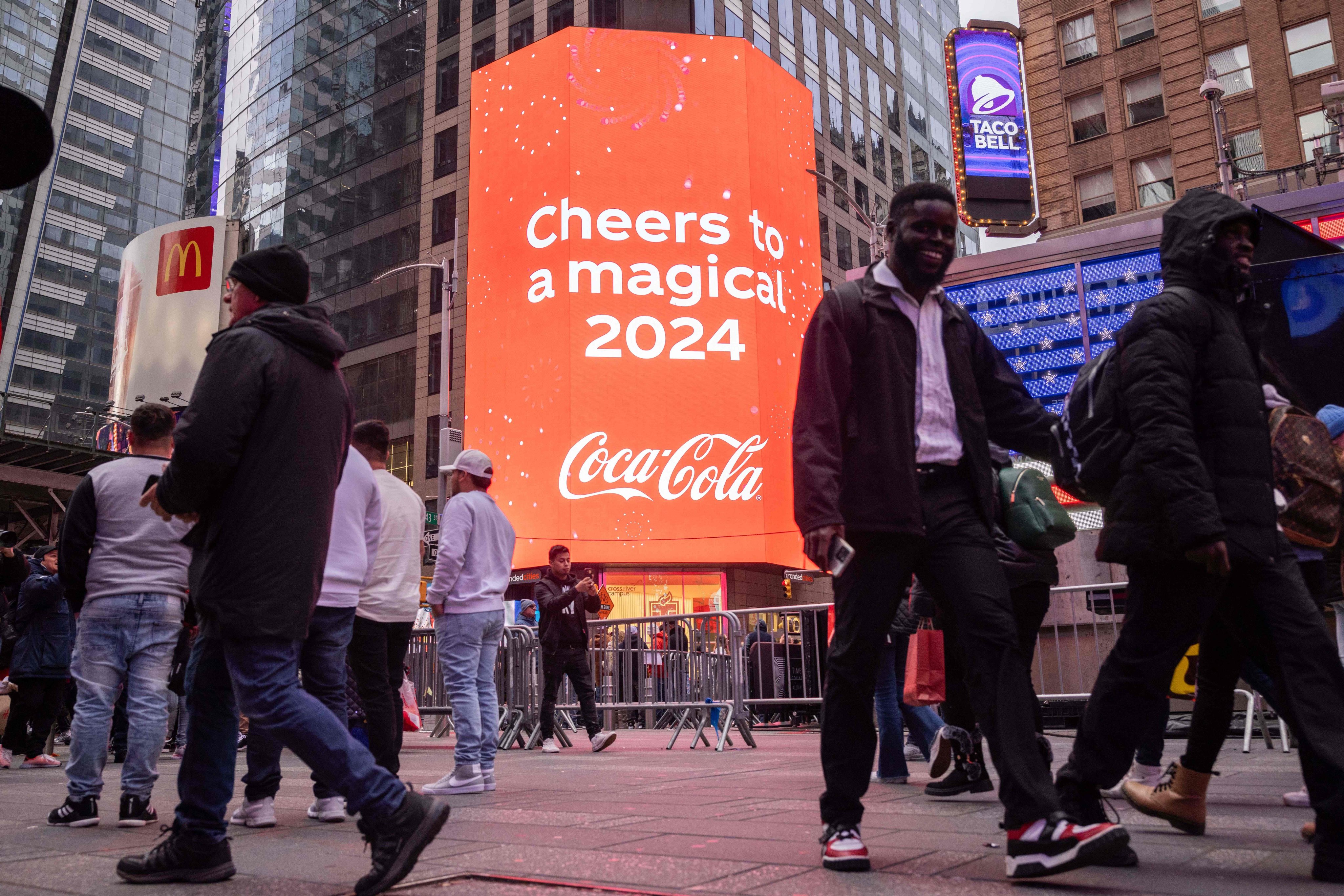 Tourists walk in Times Square on December 30, 2023, as preparations are underway for New Year celebrations in New York City. Photo: AFP