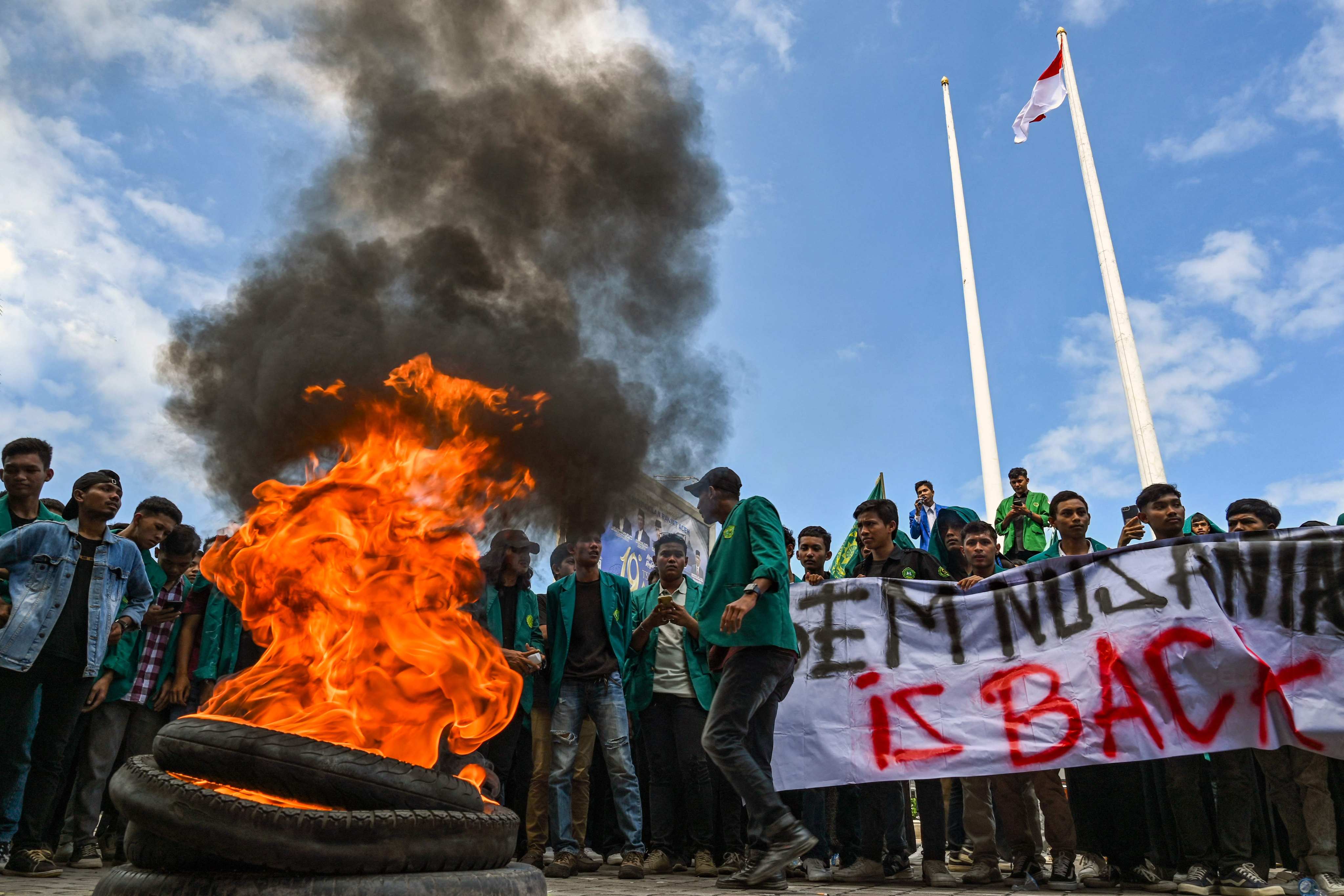 University students burn tyres as they protest against the arrival of Rohingya refugees in Banda Aceh on December 27. Photo: AFP 