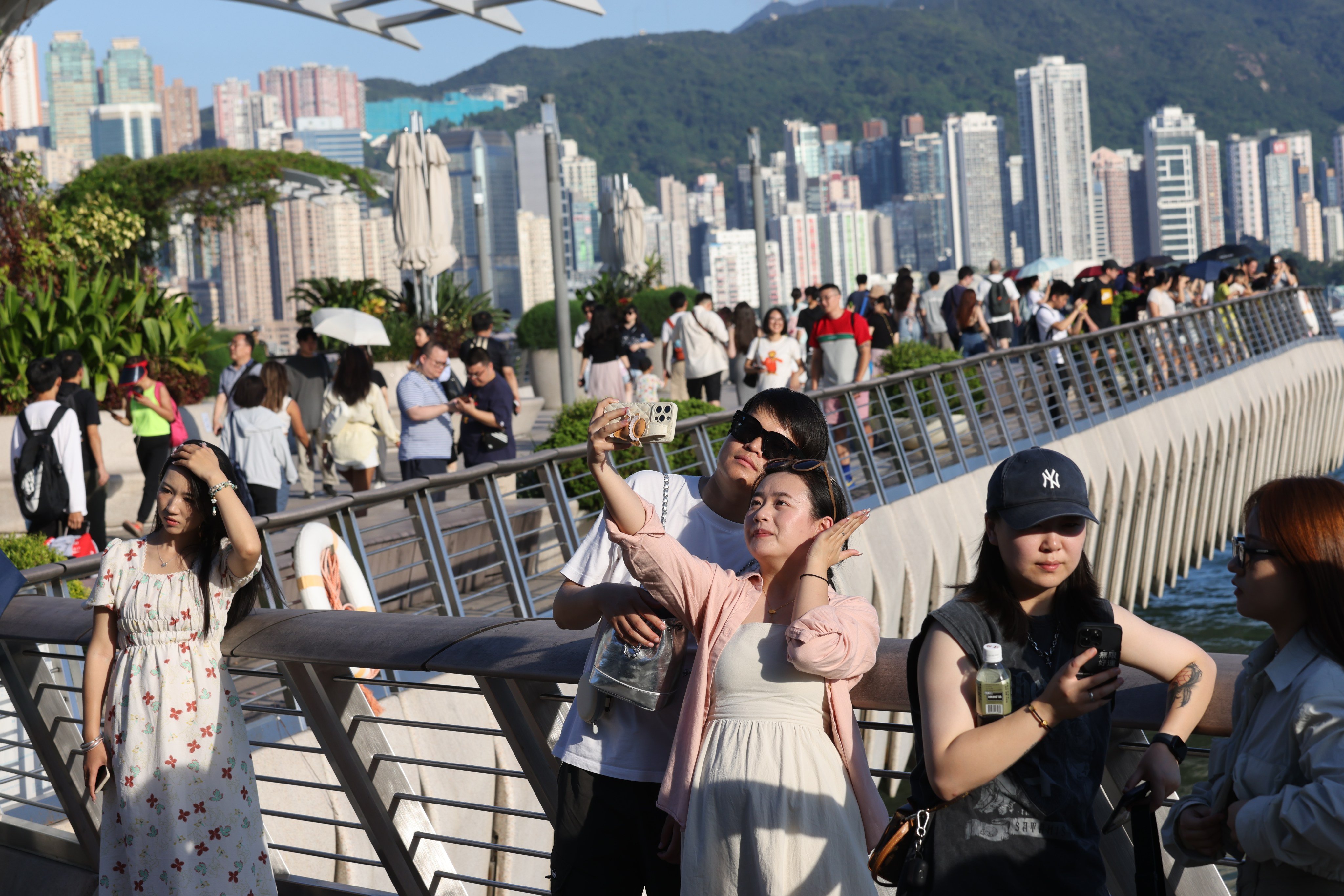 Mainland tourists visit Tsim Sha Tsui on September 28. Hong Kong dropping the last of its Covid-19 pandemic restrictions and removing the mask mandate were significant steps in returning a sense of normality to the city. Photo: Yik Yeung-man