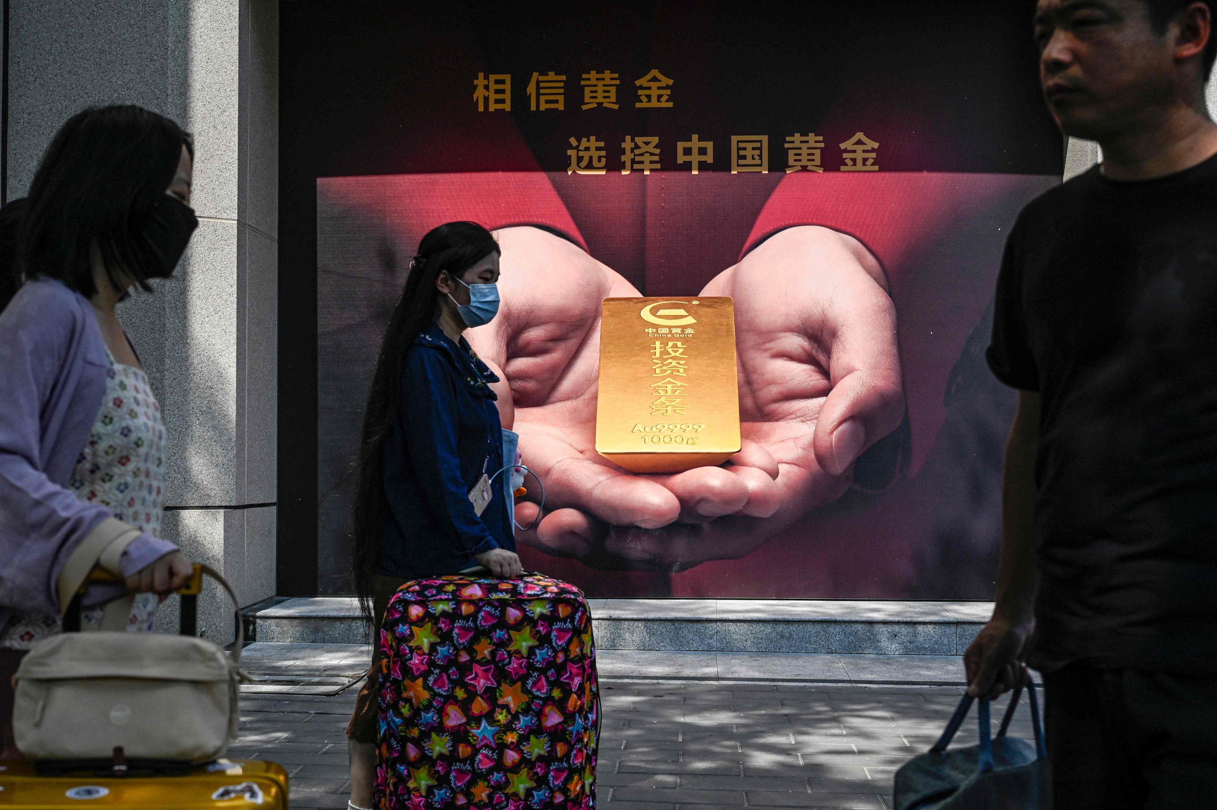 People walk past a gold shop along a street in Beijing on September 15, 2023. Fundamental demand, from record central bank purchases to robust jewellery demand, helped gold weather a challenging macroeconomic backdrop. Photo: AFP