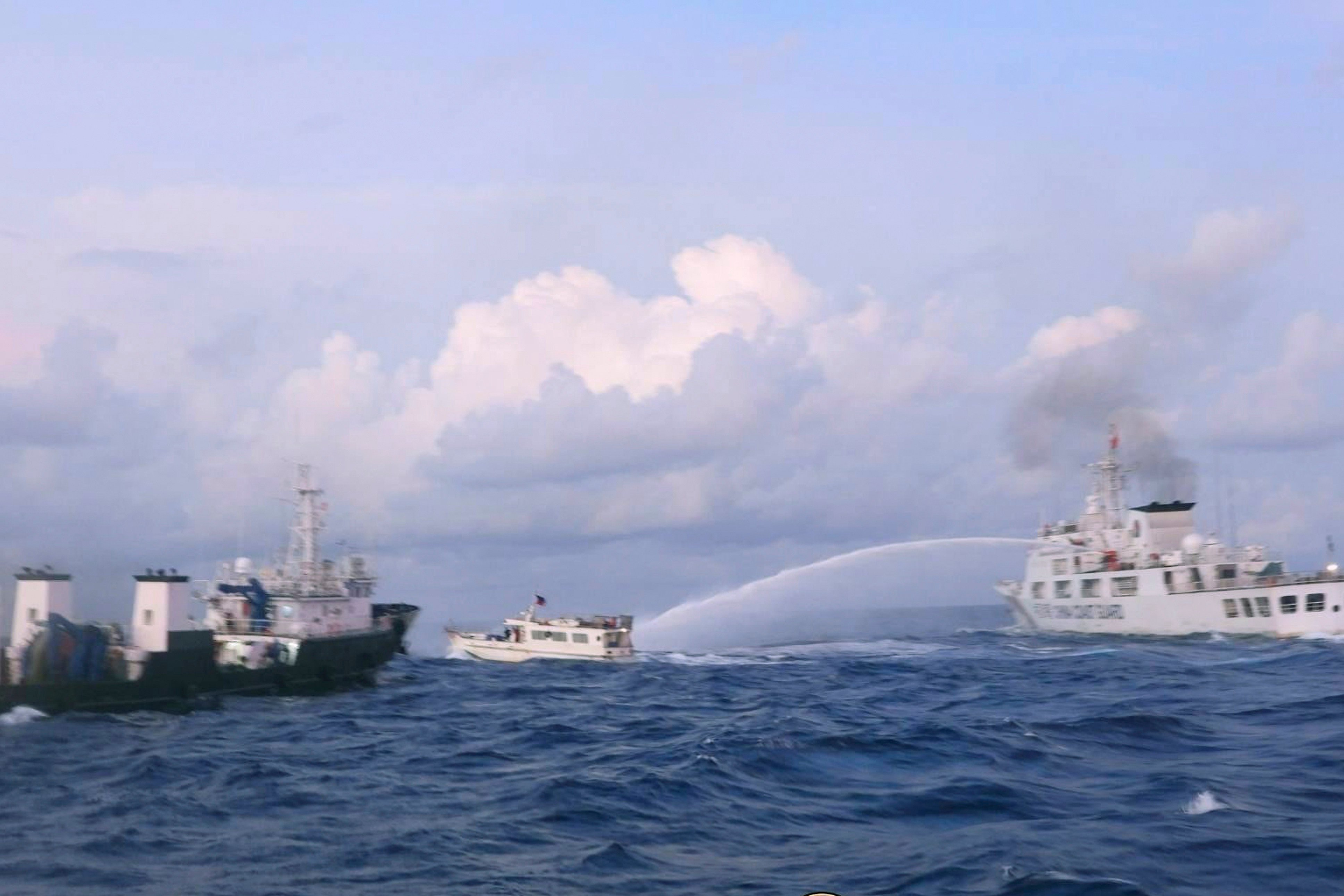 A Chinese Coast Guard ship uses water cannon on a Philippine supply boat as it approaches Second Thomas Shoal in the disputed South China Sea, on December 10. Photo: Handout from Philippine Coast Guard via AP