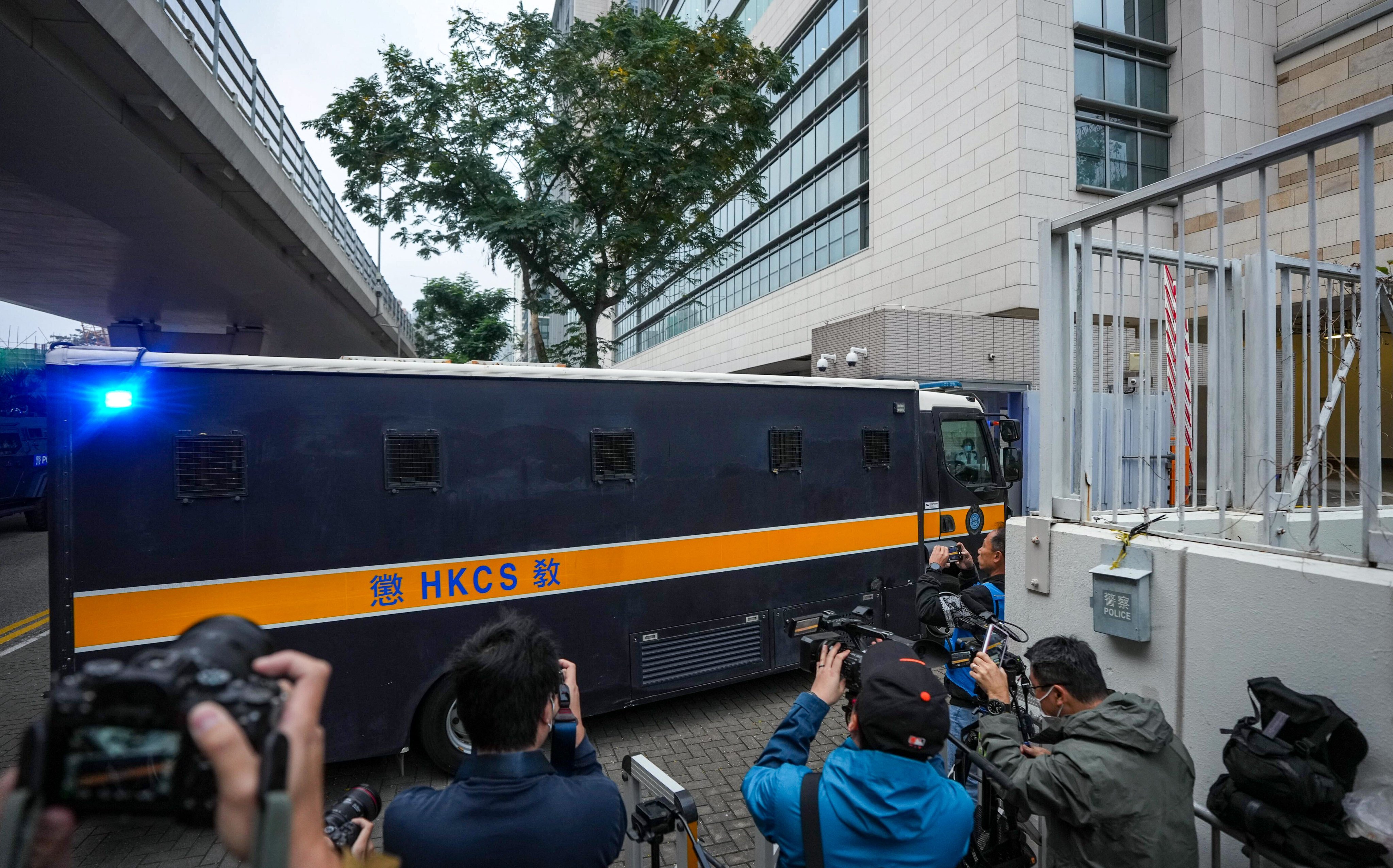 A prison van carrying Jimmy Lai arrives at West Kowloon Court. Police have been checking vehicles entering the building. Photo: Eugene Lee