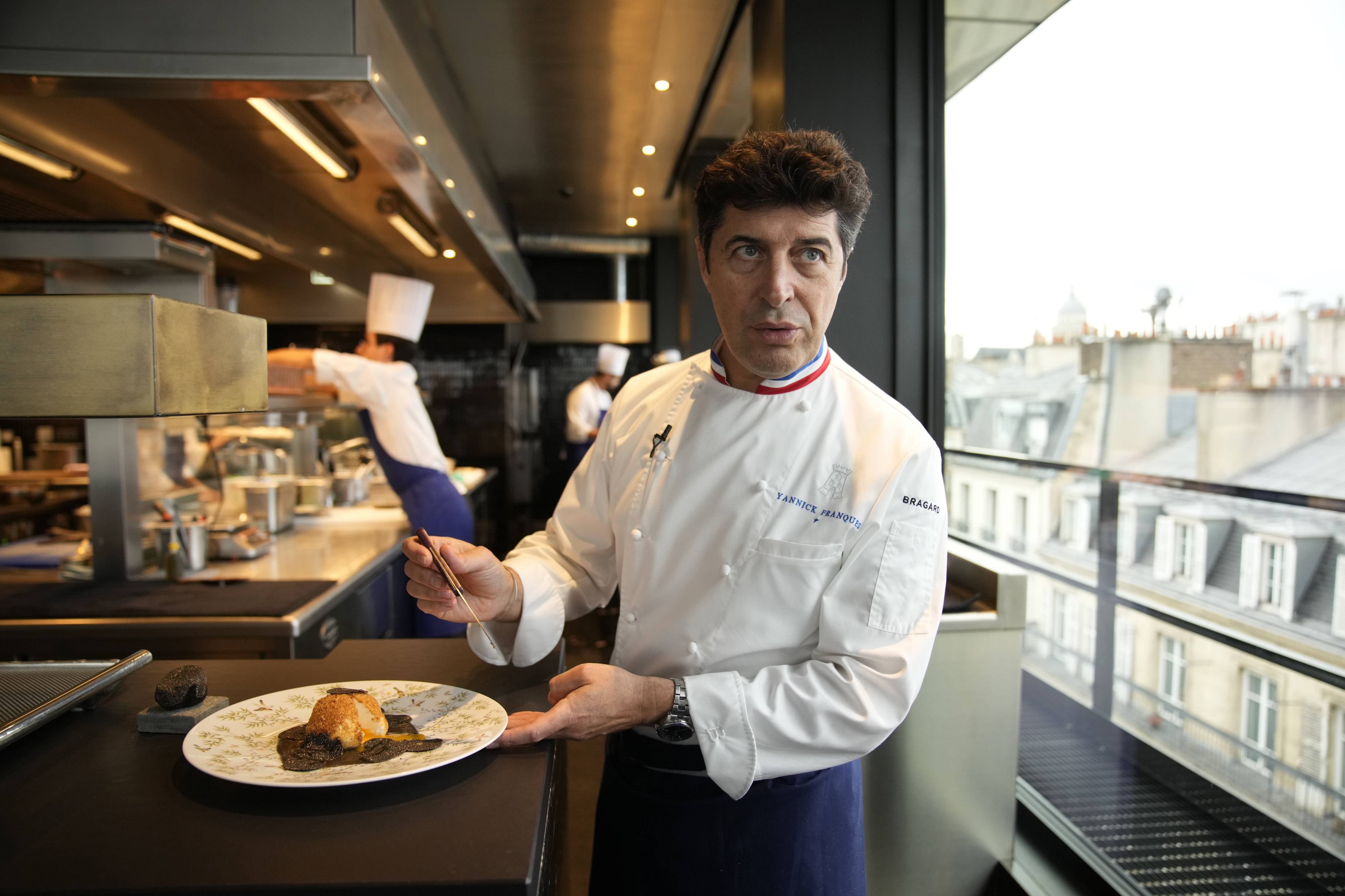 Chef Yannick Franques prepares food at La Tour d’Argent restaurant in Paris in December. Photo: AP