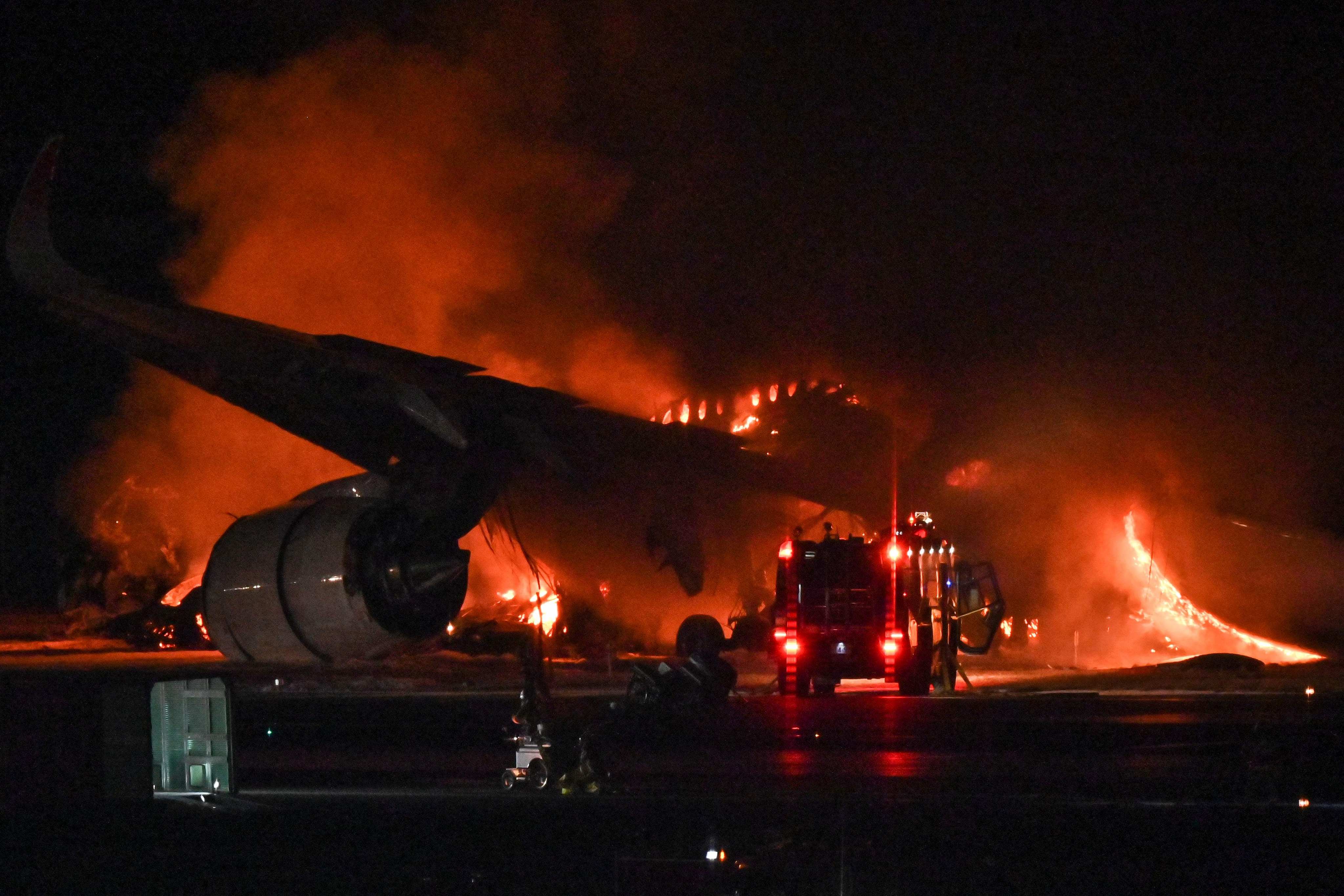 A Japan Airlines passenger plane seen on fire on the tarmac at Tokyo’s Haneda airport on Tuesday. Photo: AFP