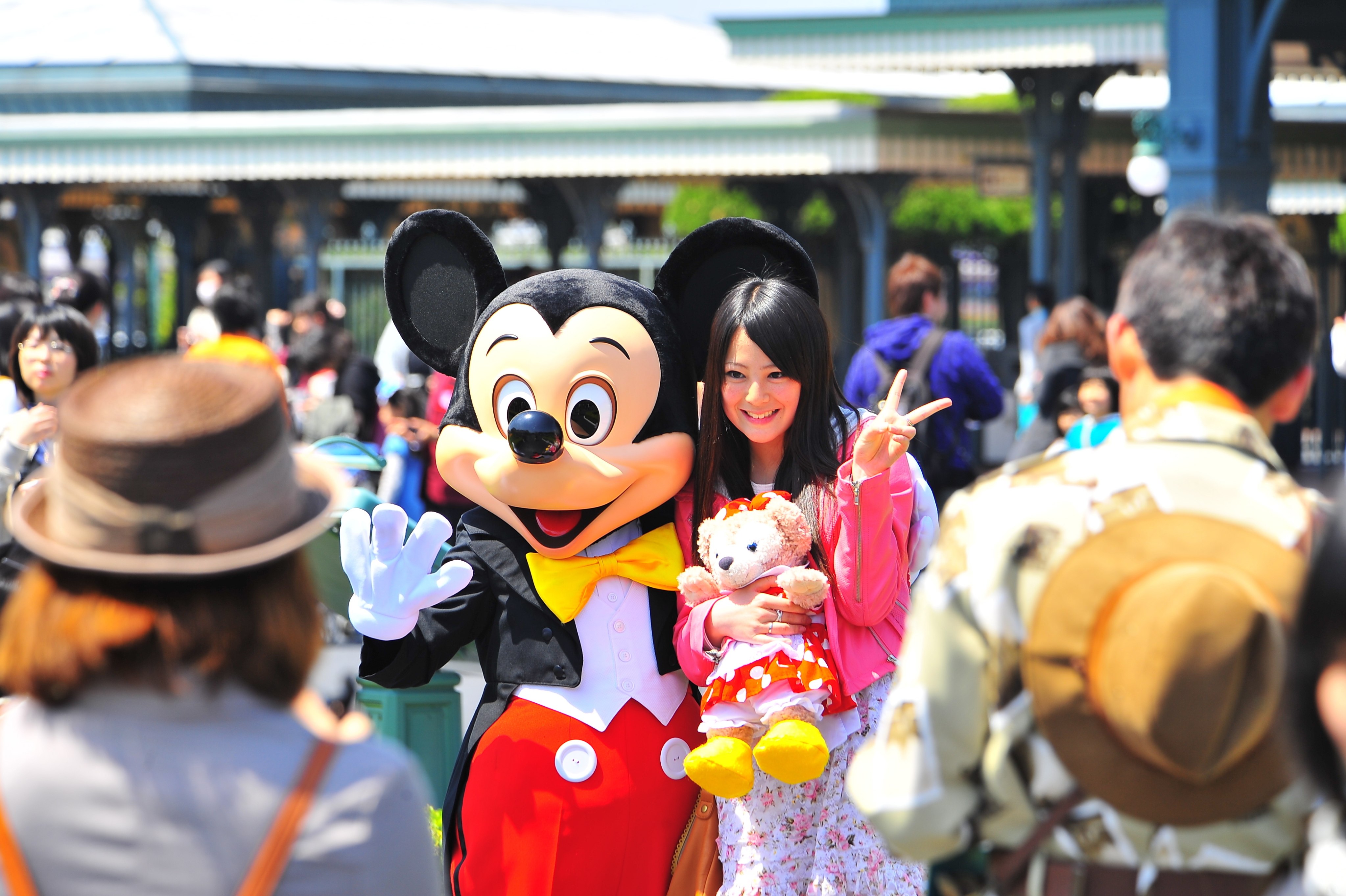Visitors pose with Mickey Mouse at Tokyo Disneyland in Japan. File photo: EPA-EFE