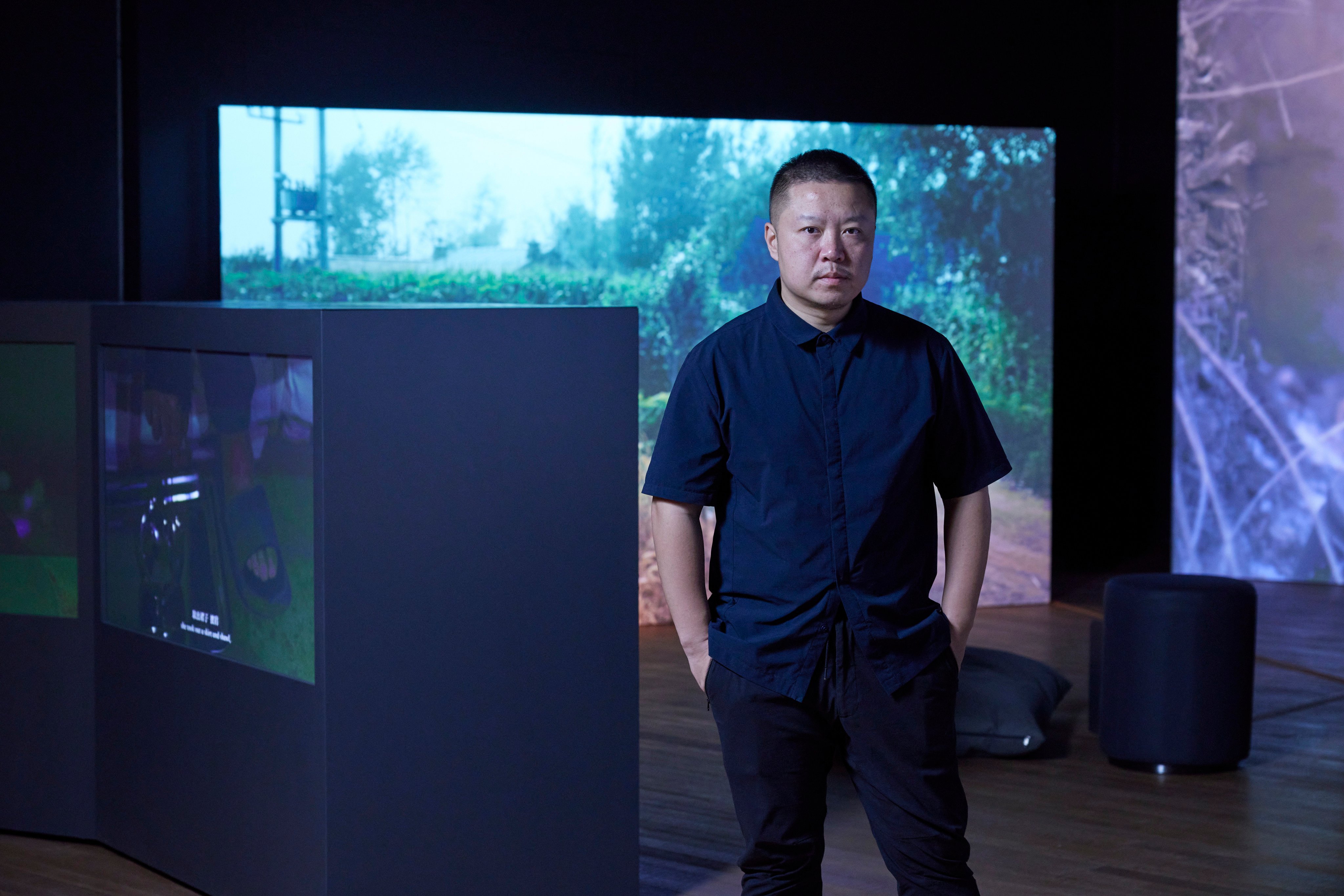 Mainland Chinese artist Wang Tuo with his award-winning video work “The Northeast Tetralogy” at the M+ Sigg Prize 2023 exhibition, in the West Kowloon Cultural District, Hong Kong. Photo: Dan Leung, courtesy of M+ Hong Kong