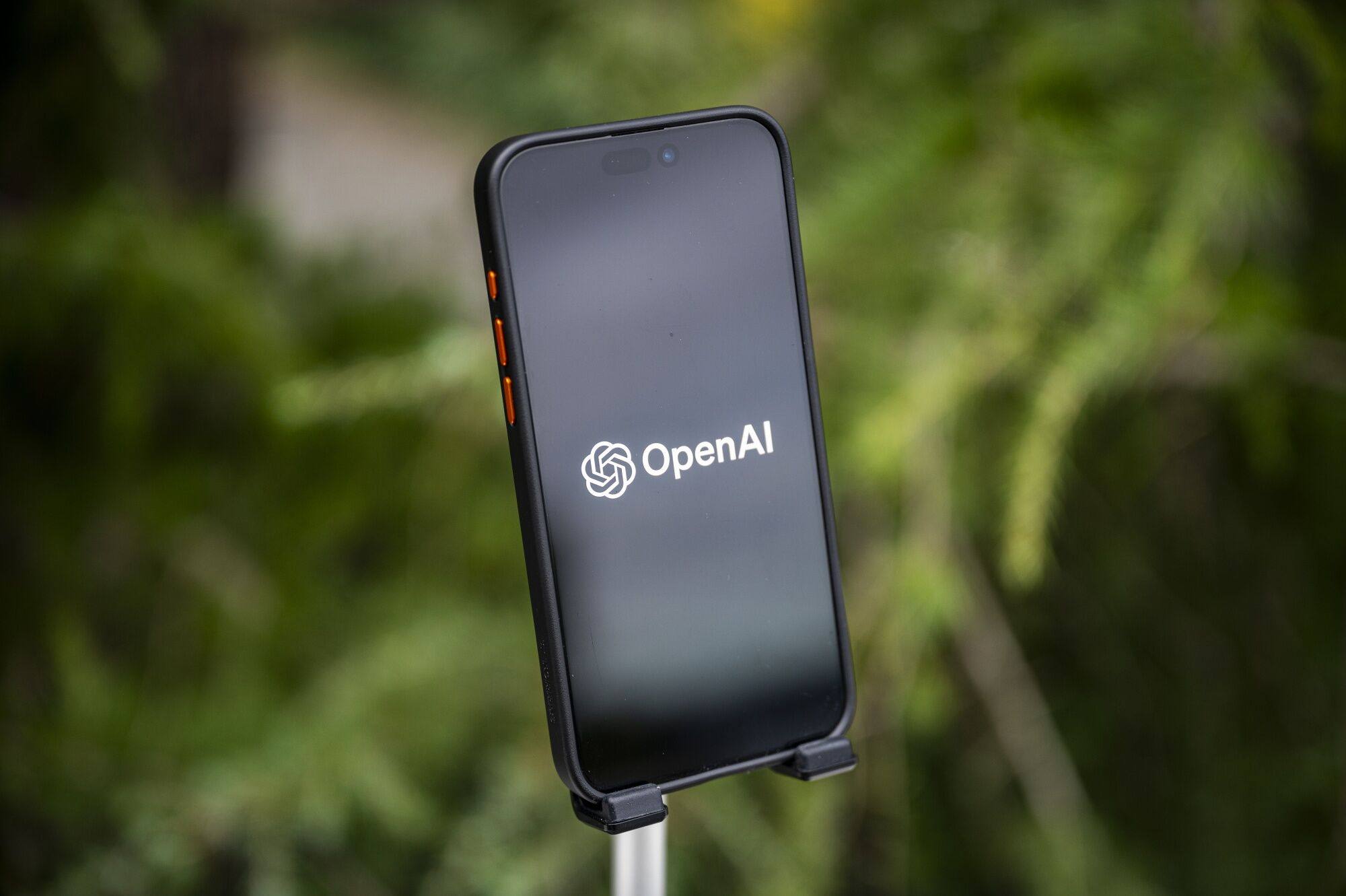 The Open AI logo is seen on a smartphone in a photo arranged on December 29, 2023. Photo: Bloomberg