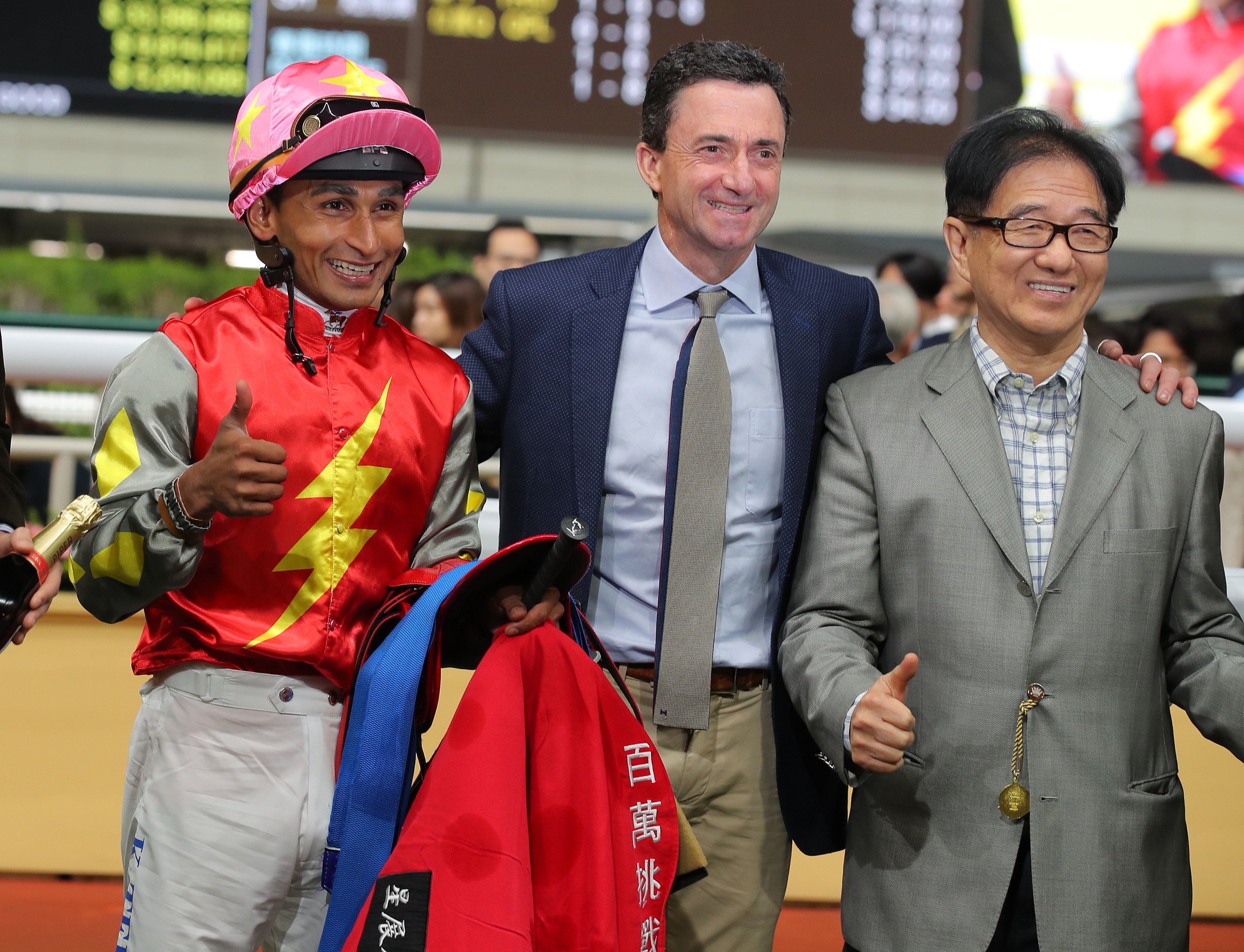 Jockey Karis Teetan and trainer Douglas Whyte celebrate with connections following Majestic Knight’s win at Happy Valley. Photo: Kenneth Chan