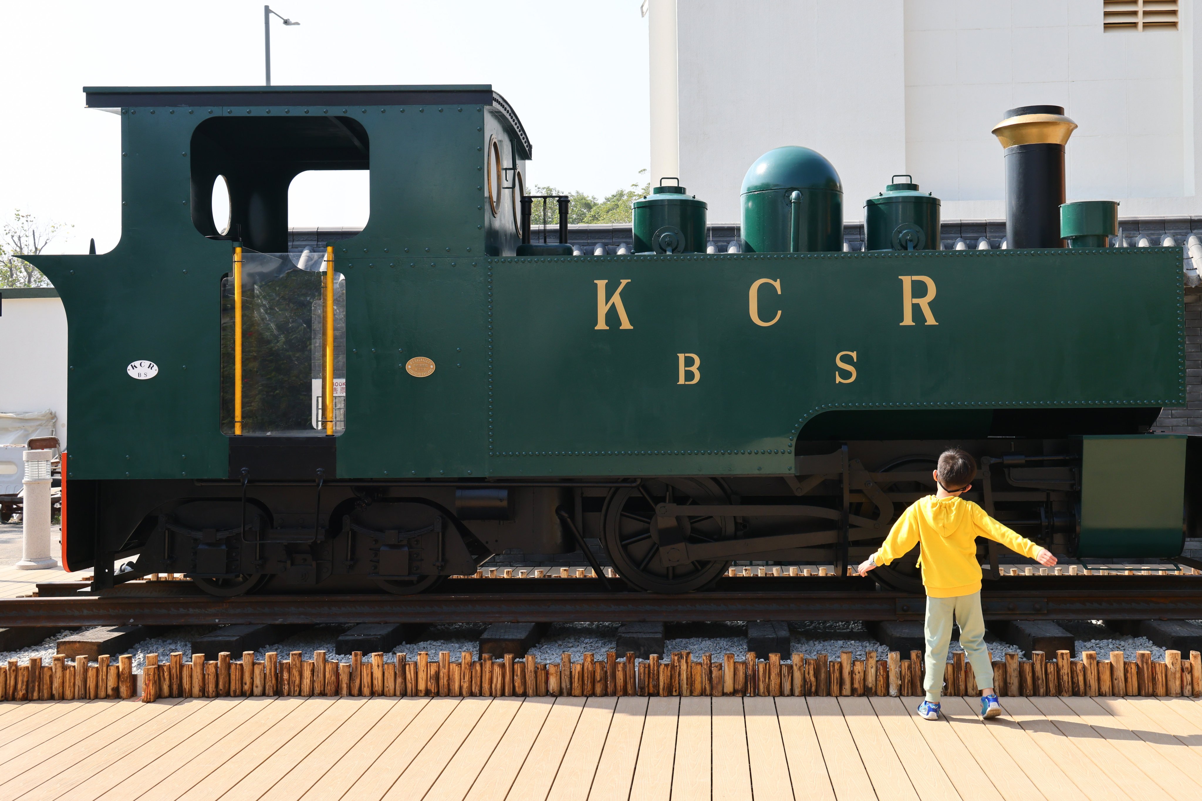 A full-size replica of an old Kowloon-Canton Railway steam engine, one of the attractions at time capsule border town Sha Tau Kok, attracts a young admirer. Photo: Dickson Lee