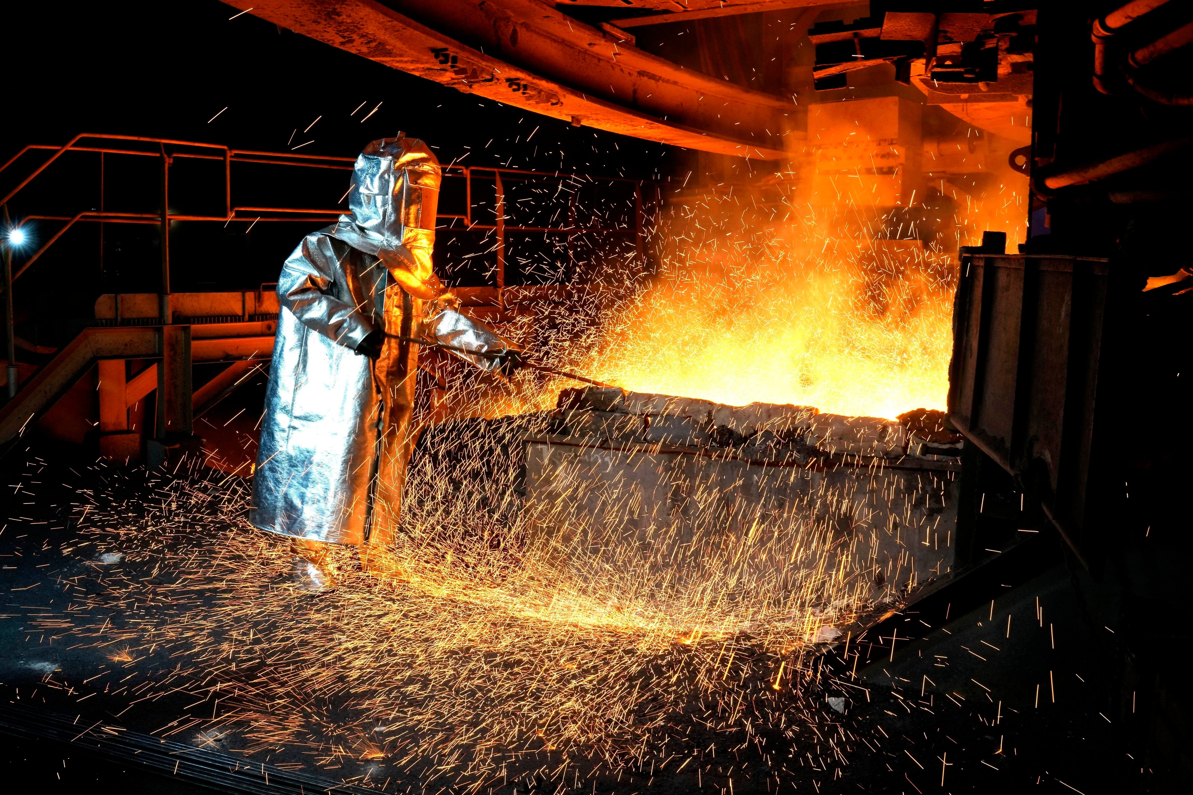 A worker in a protective suit works a smelting furnace at a nickel-processing plant in South Sulawesi, Indonesia, last year. Photo: AP