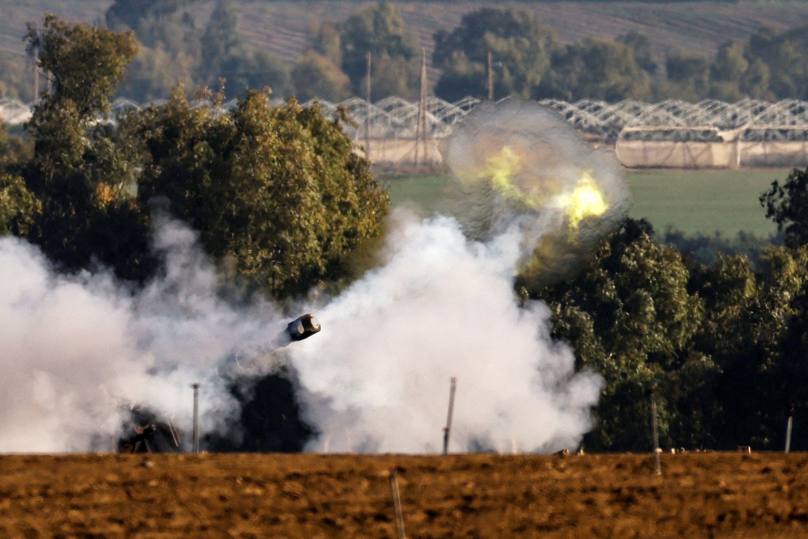 An Israeli artillery unit fires near the Gaza border on Saturday. Photo: Reuters