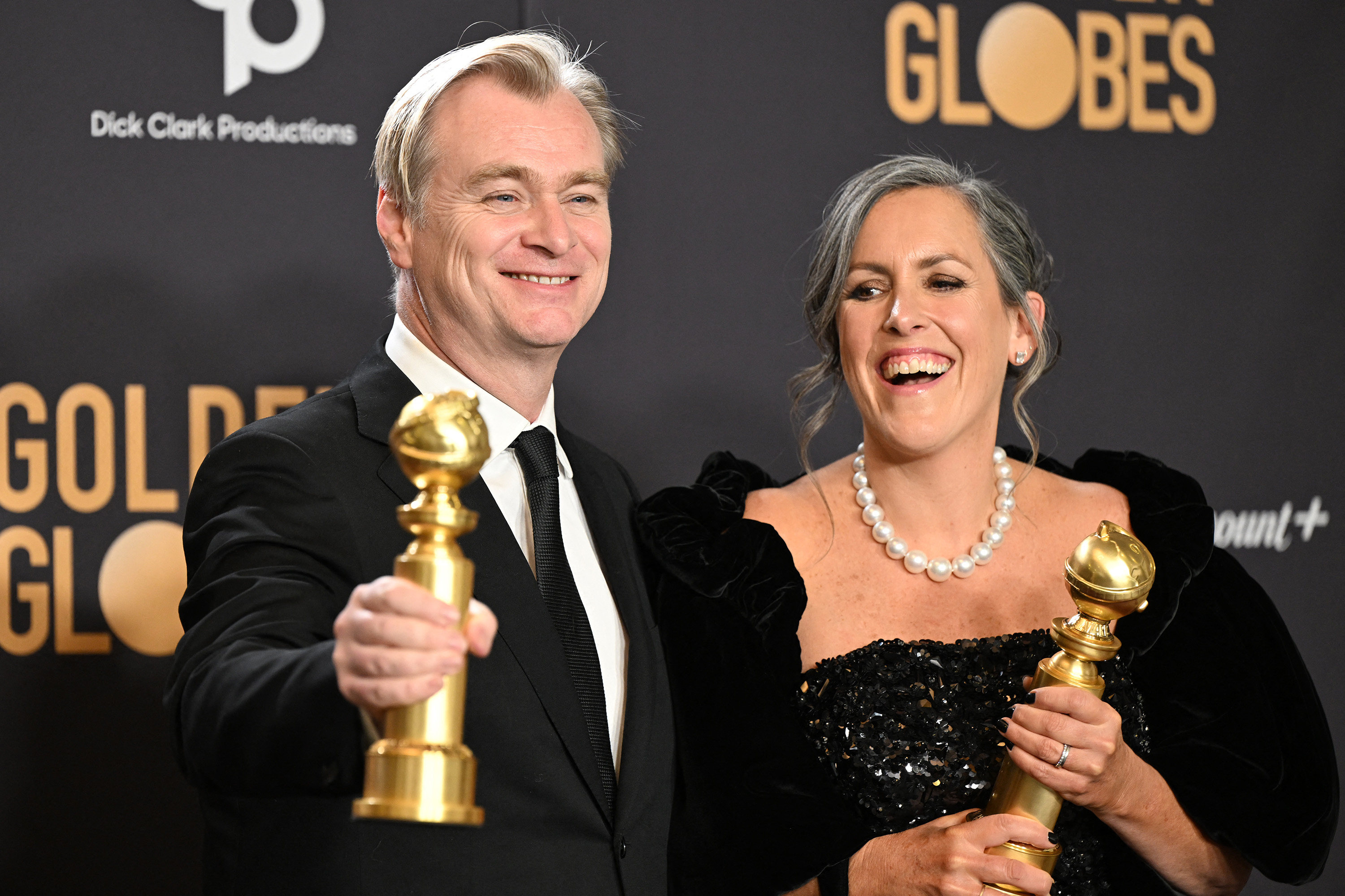 British director Christopher Nolan and his spouse, film producer Emma Thomas, pose with the Golden Globes for best director and Best motion picture - drama for “Oppenheimer” backstage at the 2024 Golden Globe Awards in Beverly Hills, California. Photo: AFP/Getty Images/TNS