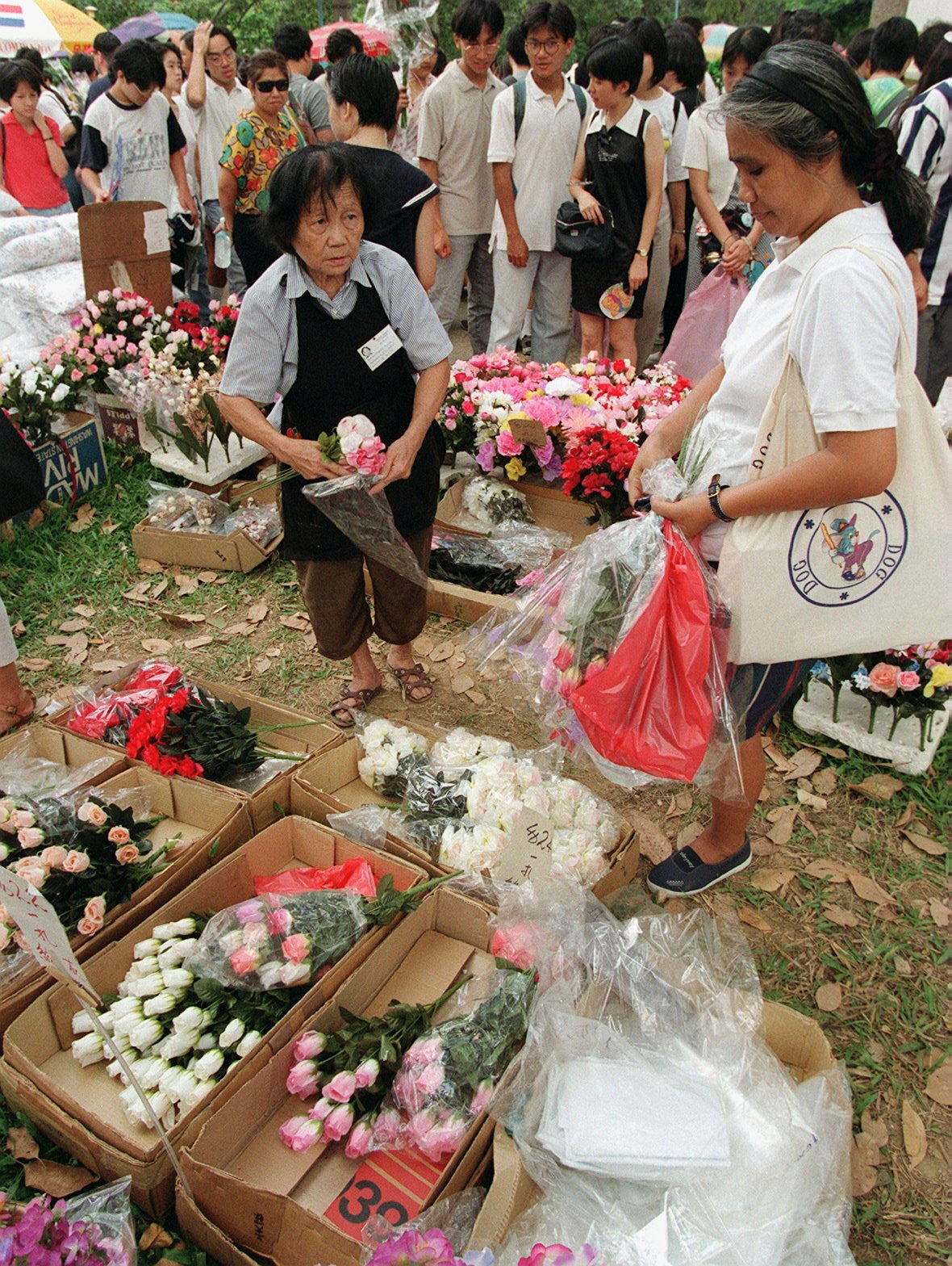 An artificial-flower seller at Shek Kong Friday market on its final day in 1996. The weekly bazaar was a favourite of British service wives living in married quarters near the then remote village, but in closing down it became reduced to mere memory for those who shopped there. Photo: SCMP
