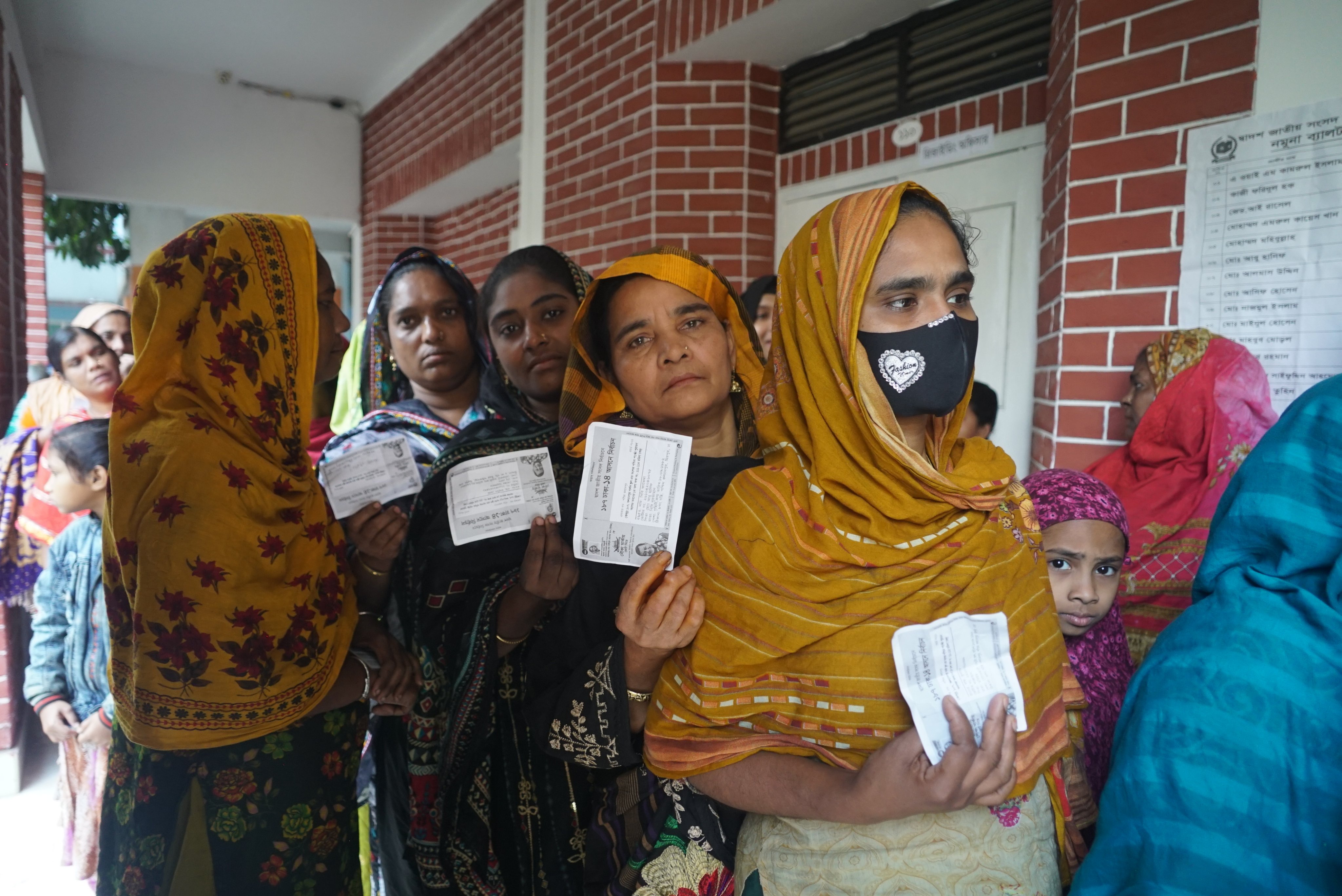 Voters queue up at a polling station in Dhaka on Sunday. Photo: Xinhua