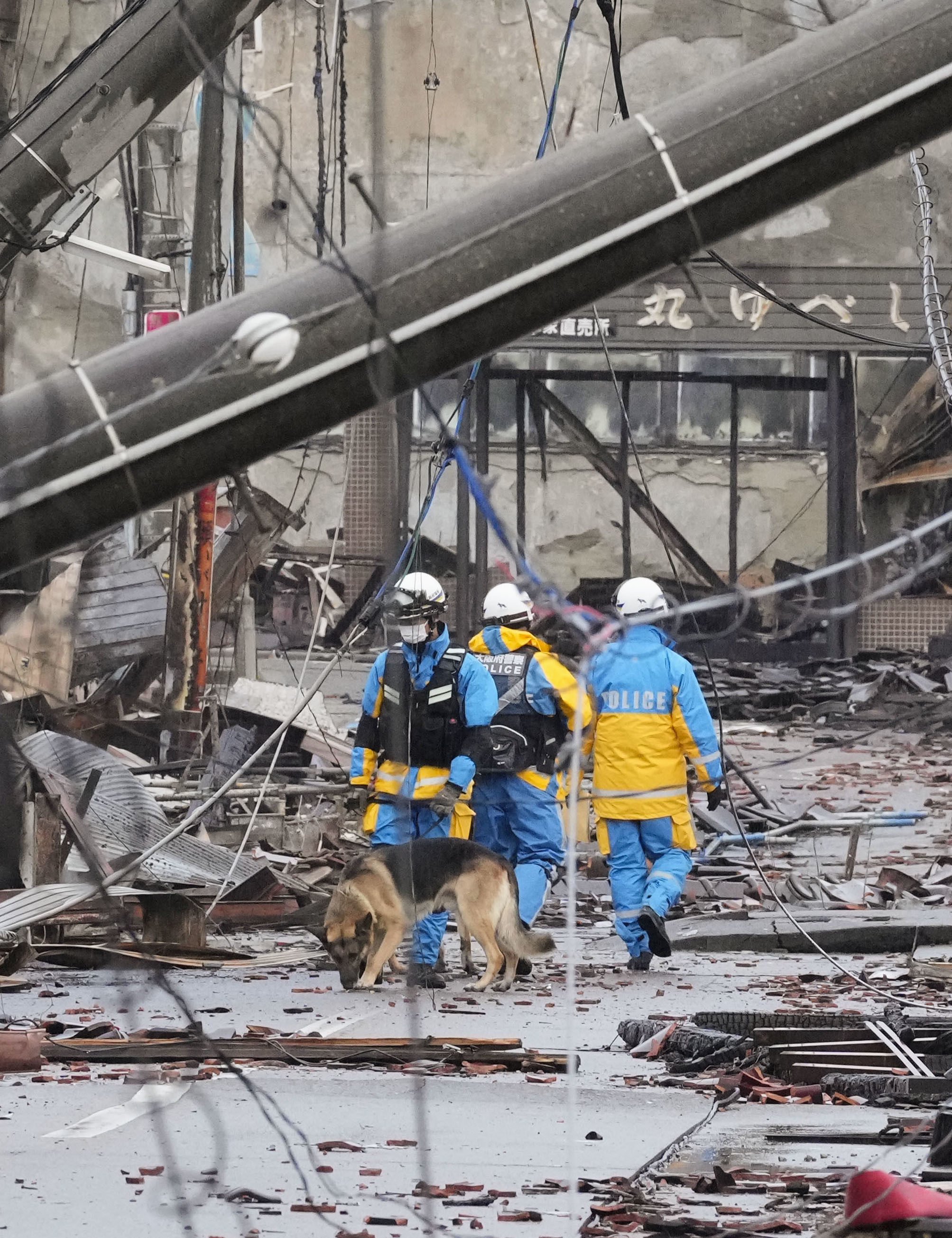 Police officers search for survivors in Japan’s Ishikawa prefecture on Sunday following the deadly New Year’s Day earthquake. Photo: Kyodo