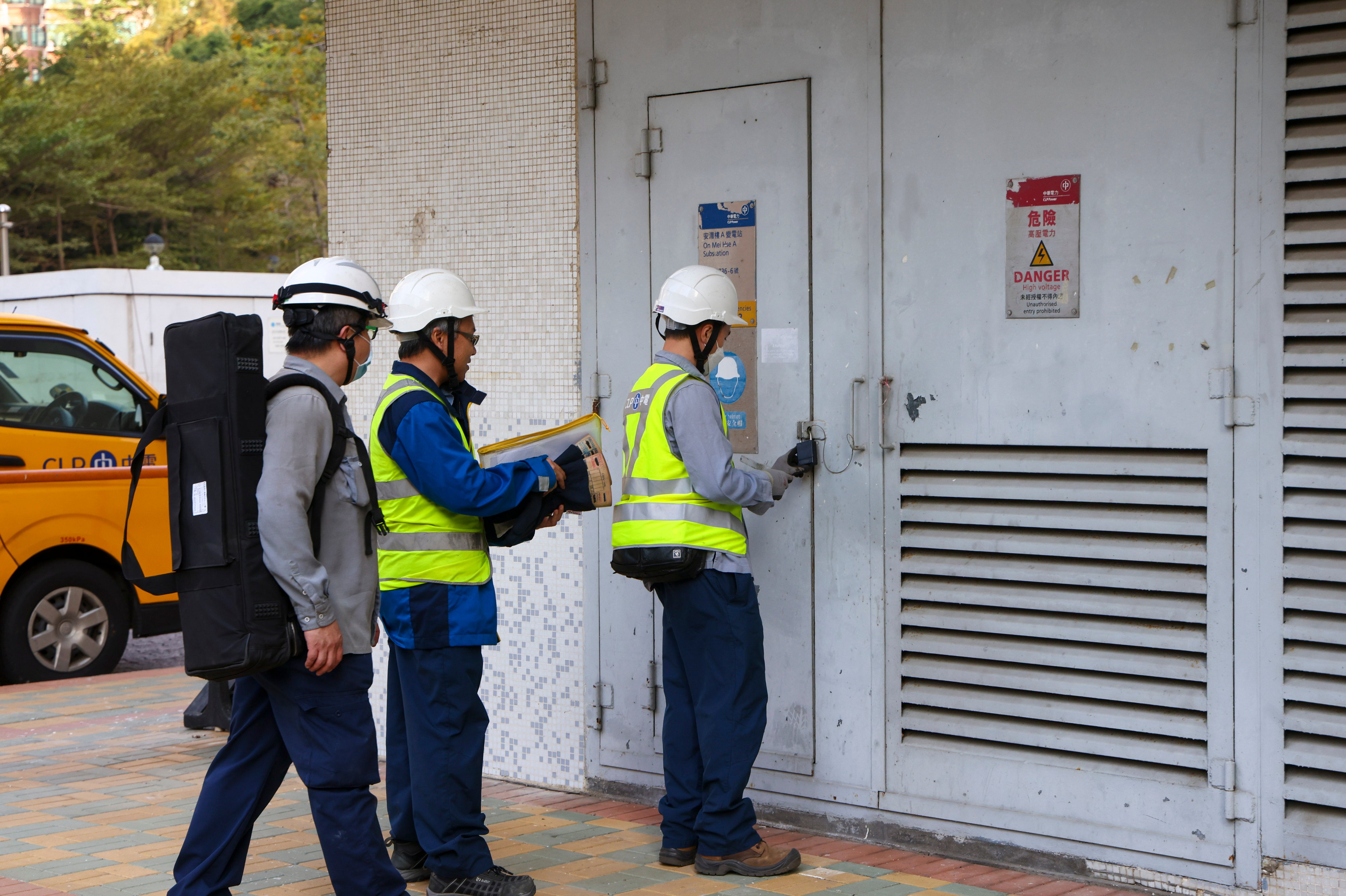 CLP engineering personnel enter a transformer electrical room during a power outage at On Mei House Building in Cheung On Estate in Tsing Yi on Sunday. Photo:  Dickson Lee