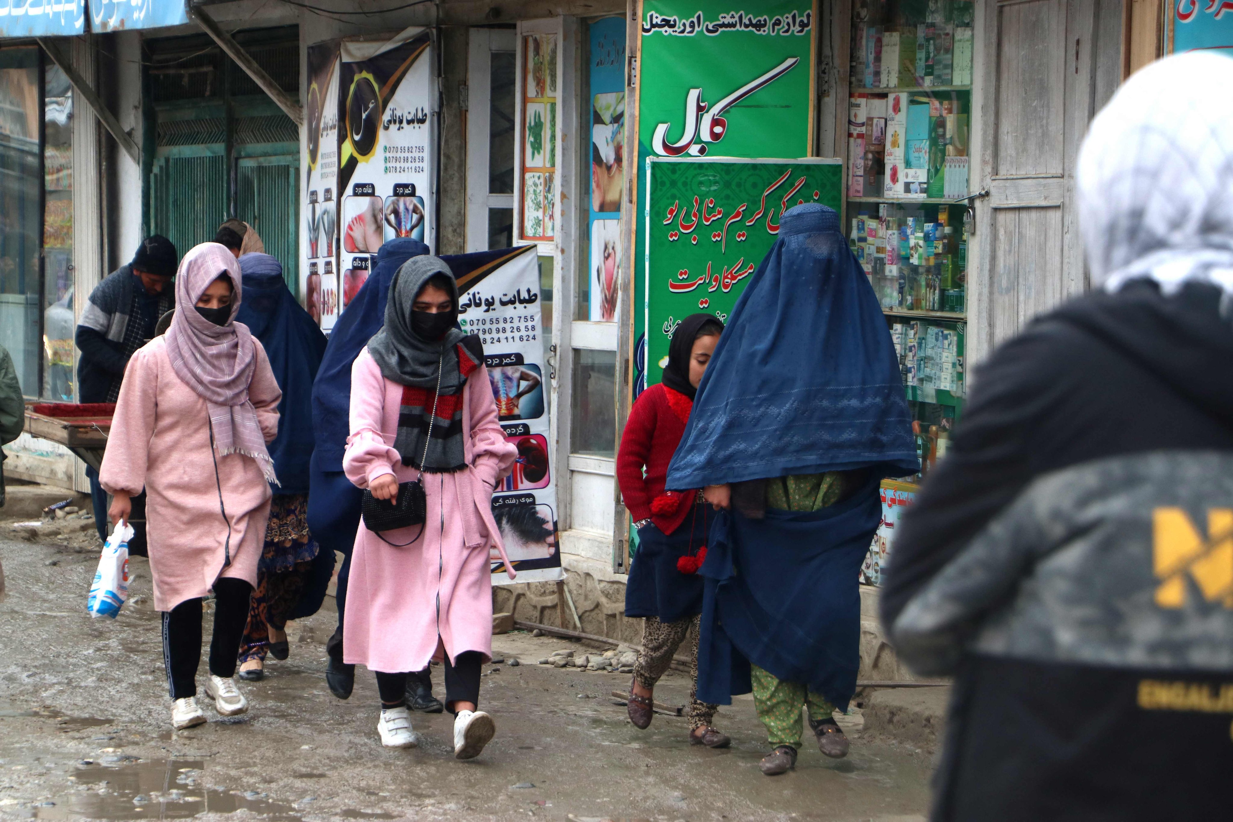 Afghan women walk along a street at a market in the Fayzabad district of Badakhshan province on December 12. Photo: AFP