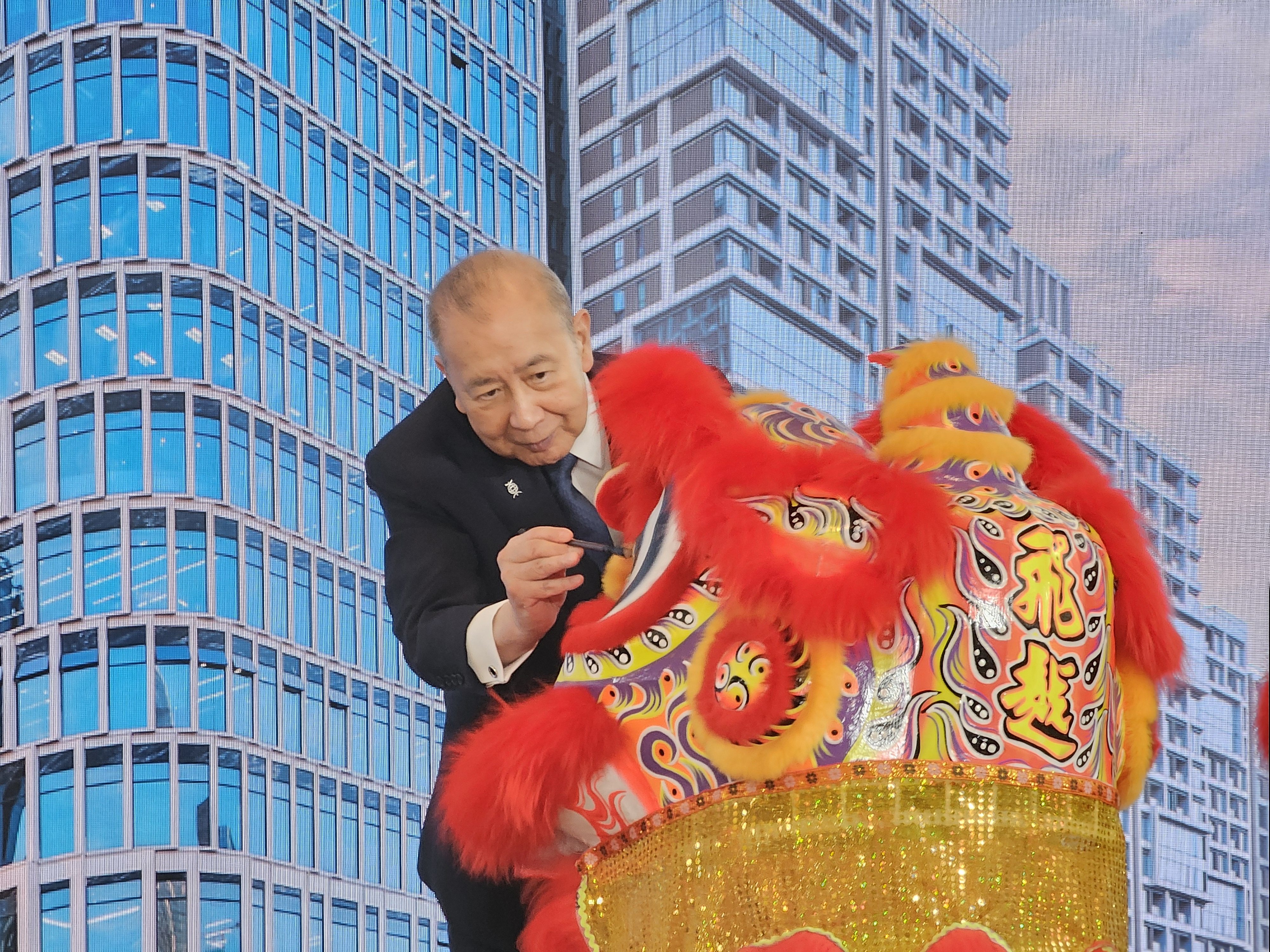 Bank of East Asia executive chairman David Li dots the eye of a lion before the ceremonial lion dance at the inauguration of the BEA Tower in Qianhai, Shenzhen, on Friday. Photo: Enoch Yiu