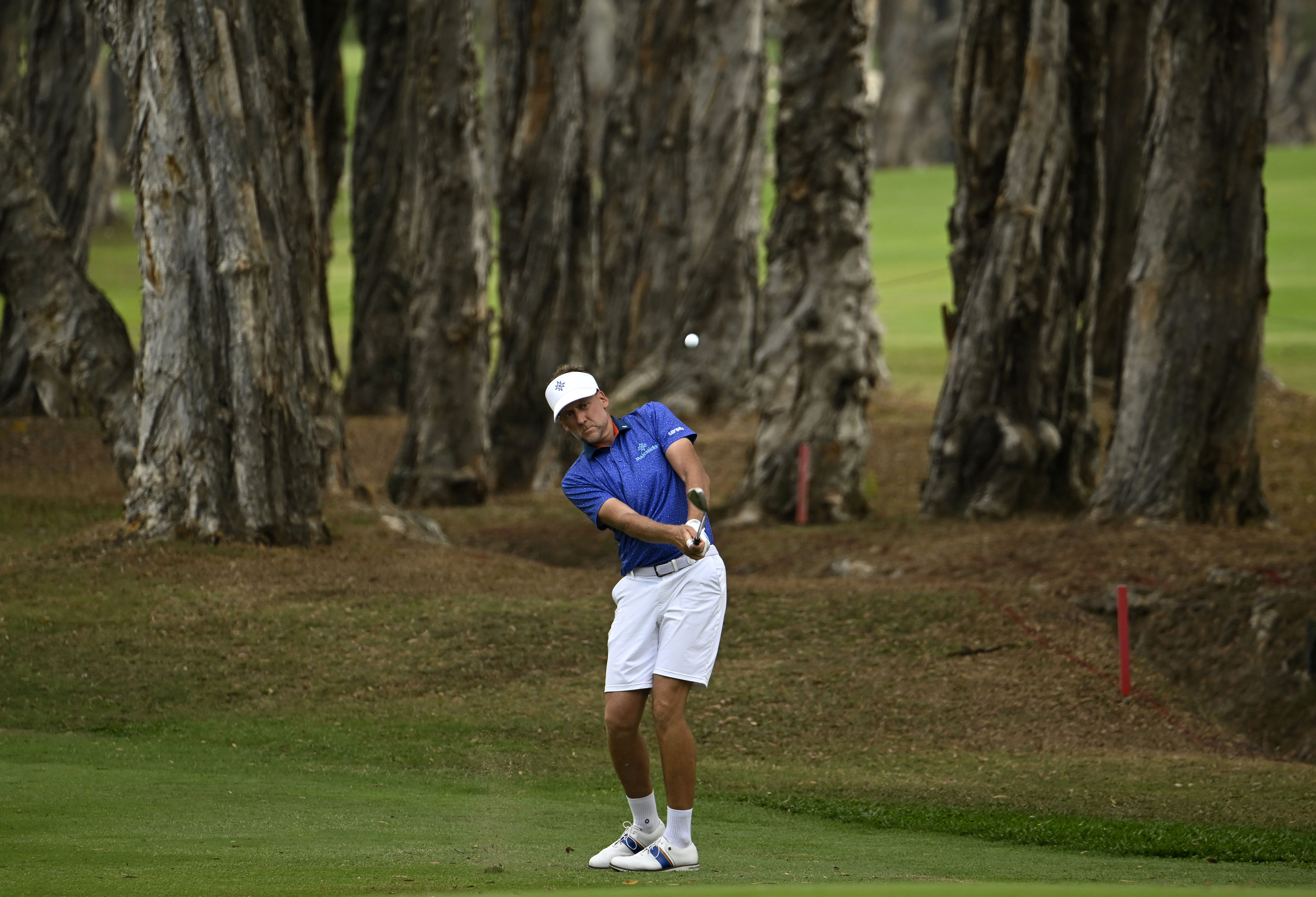 Ian Poulter hits an approach during the second round of the World City Championship at Hong Kong Golf Club. Photo: Asian Tour